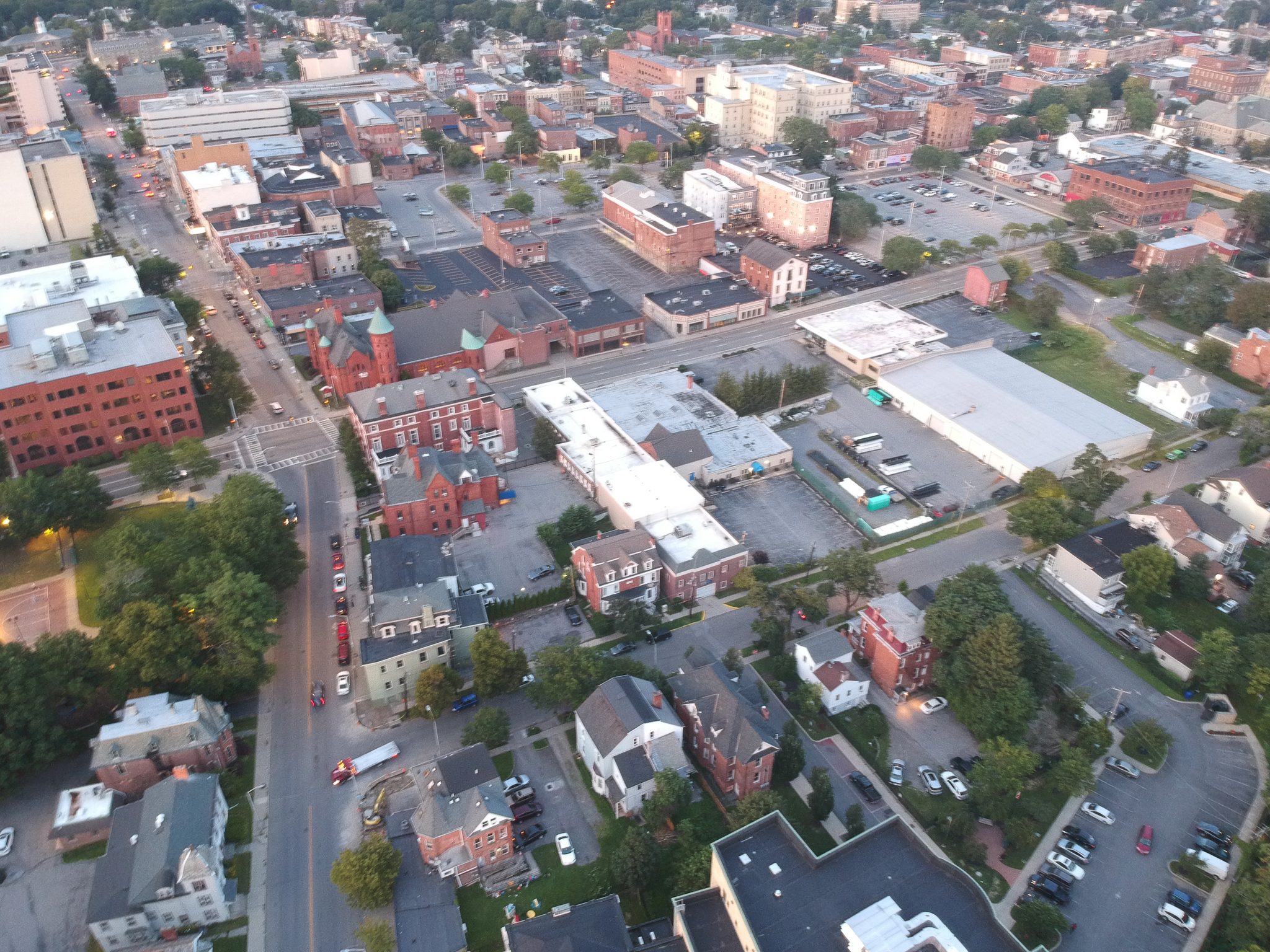 Straight down over downtown: rooftops, parking lots and the city grid.