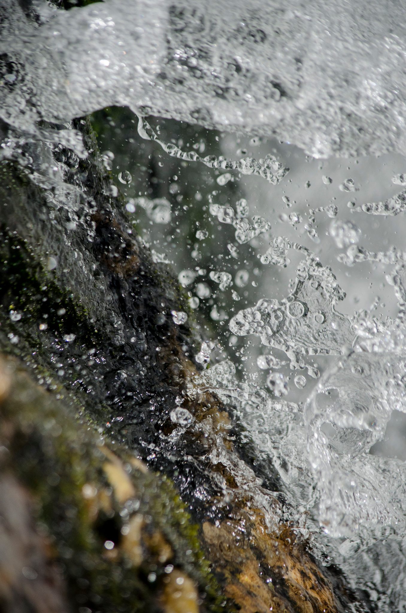 Close in, the falls break into glass and bubbles over the rock.