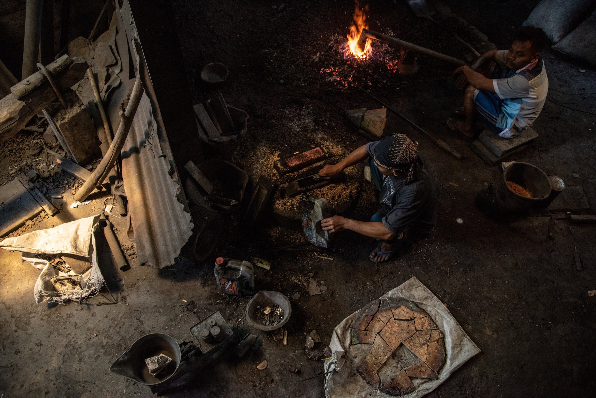 Gamelan maker prepares the zinc and iron ore for melting
