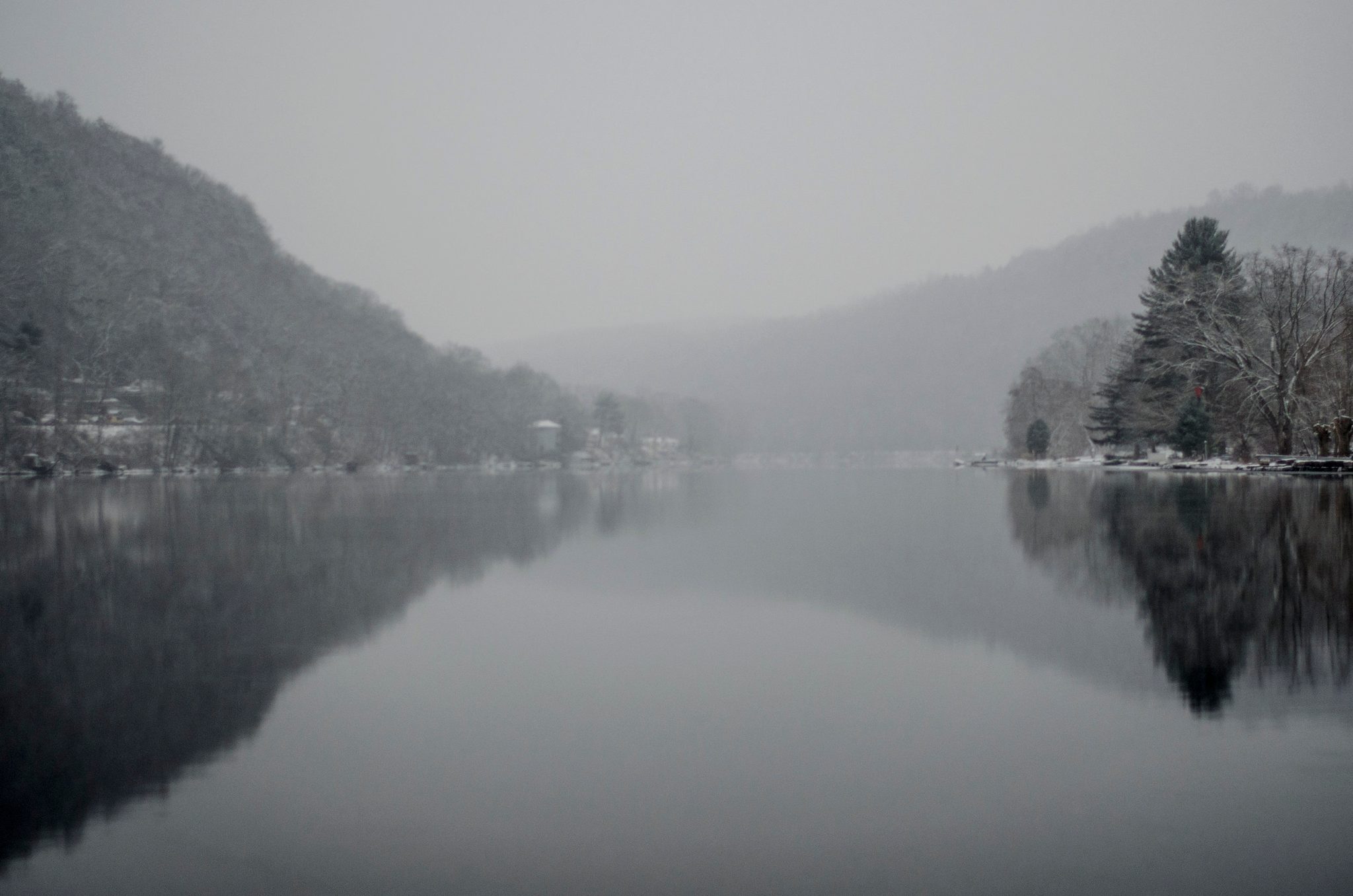 Mist hangs between the hills as the river lies perfectly still.