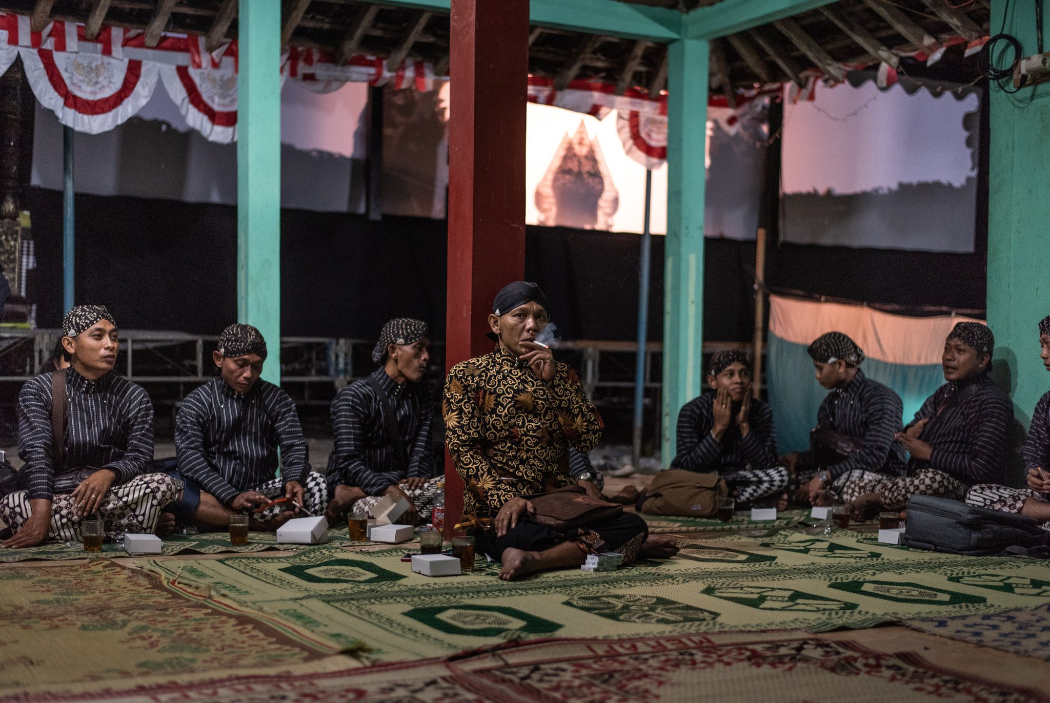 Ki Senu Nugruho sits back stage with his orchestra before they begin their performance.