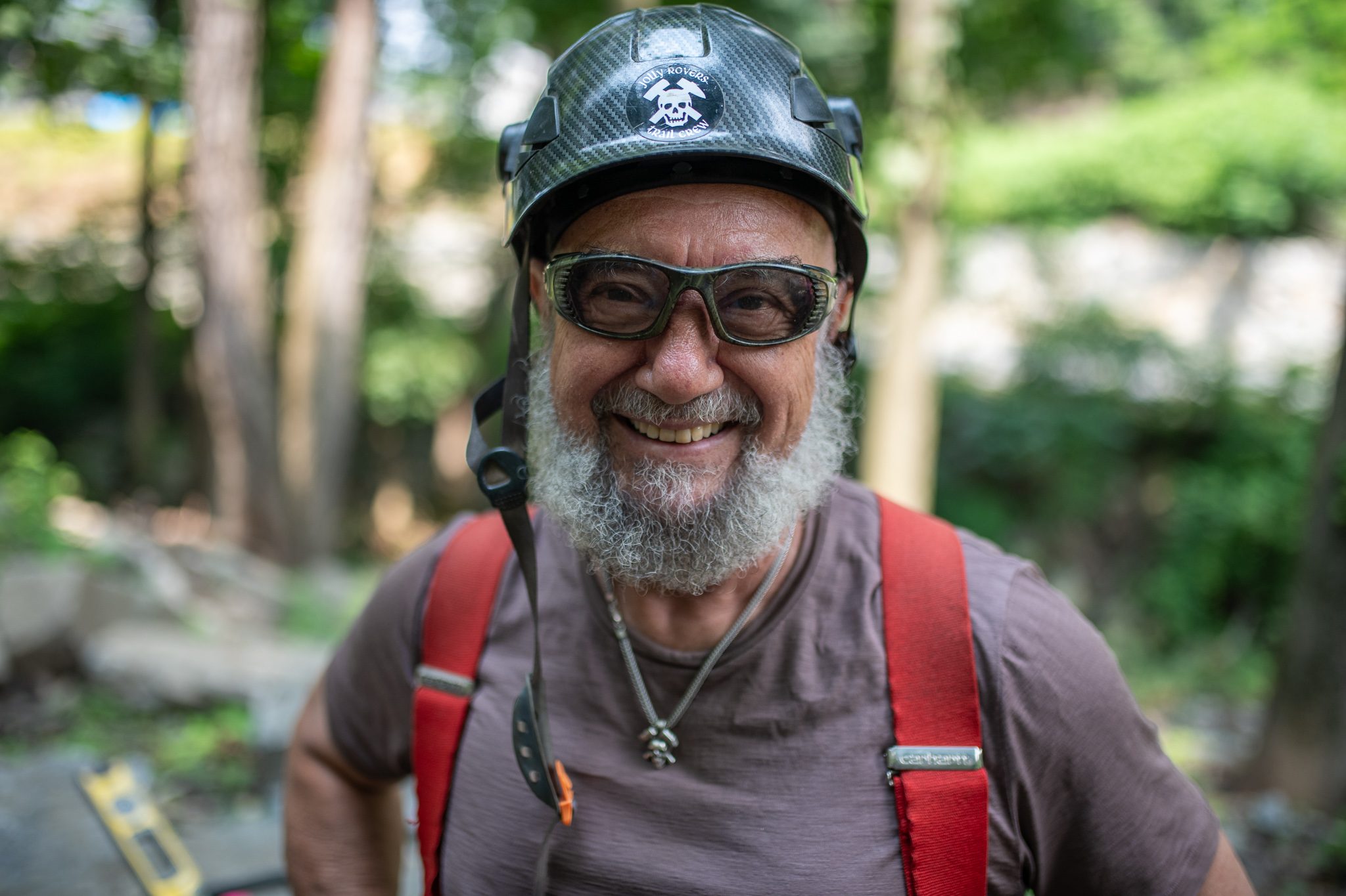 A wide smile beneath the black helmet.