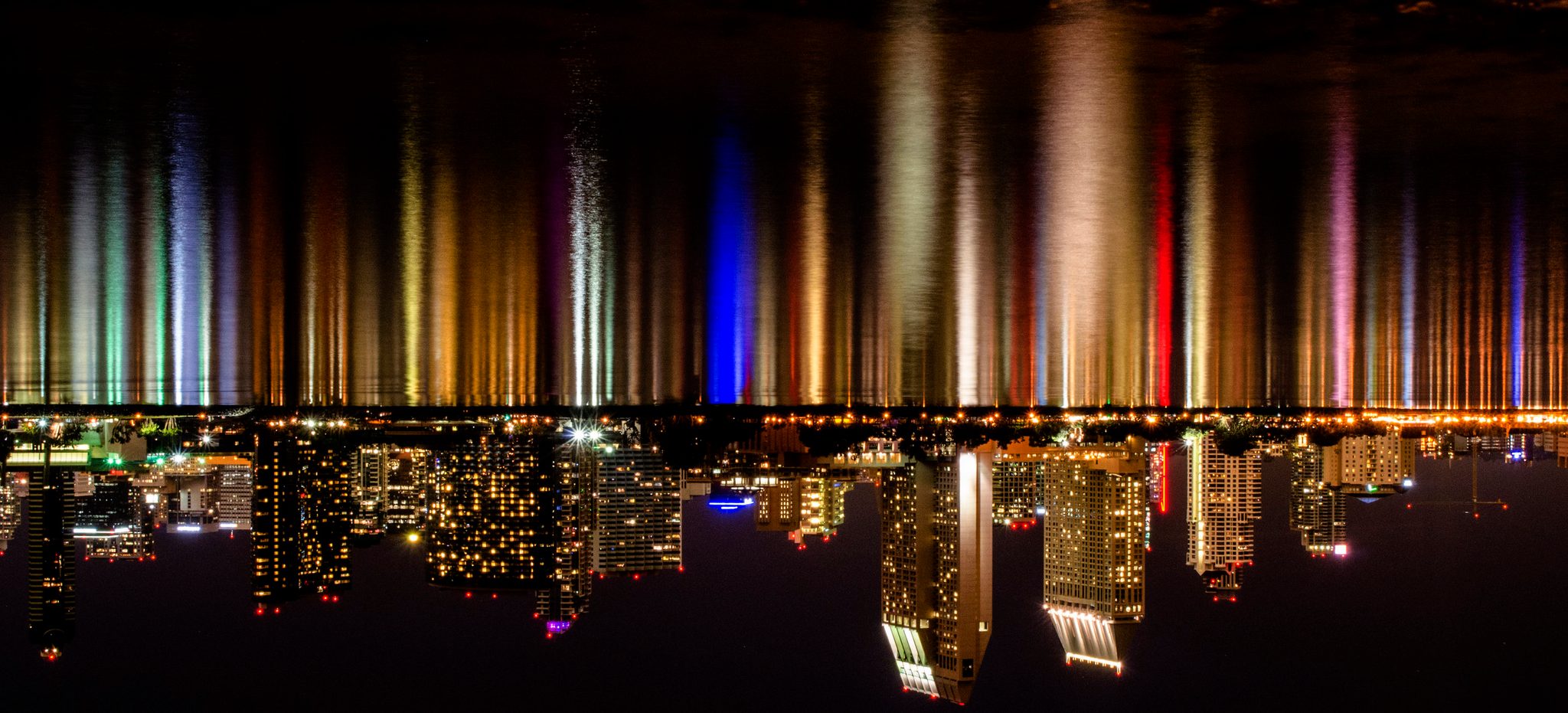 The city's lights stretch into long streaks of color, turned on their head.