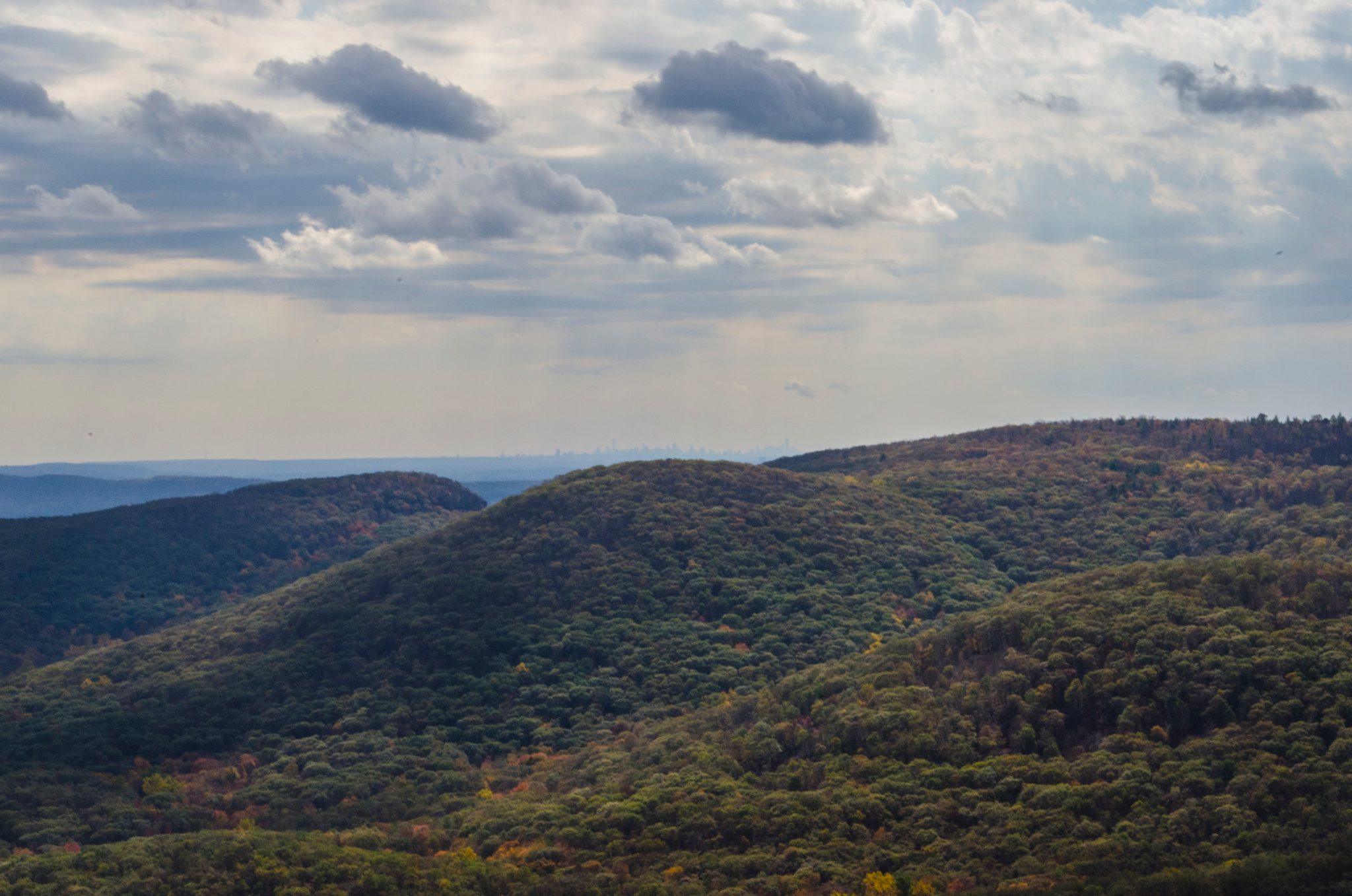 Forested ridges roll away toward a far horizon.