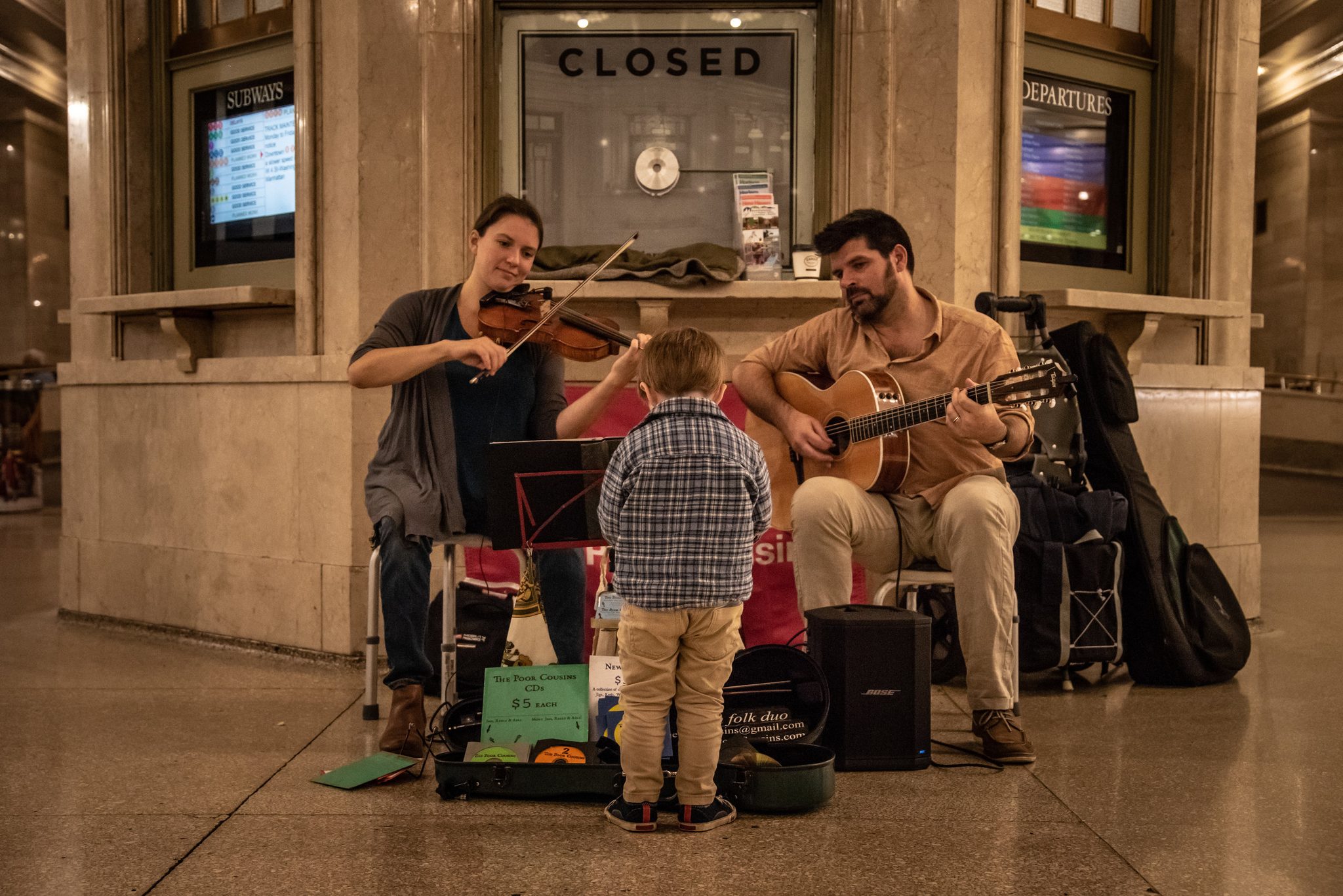 At the closed ticket window in Grand Central, Naomi and Emmet play while Ronin plants himself front and center.
