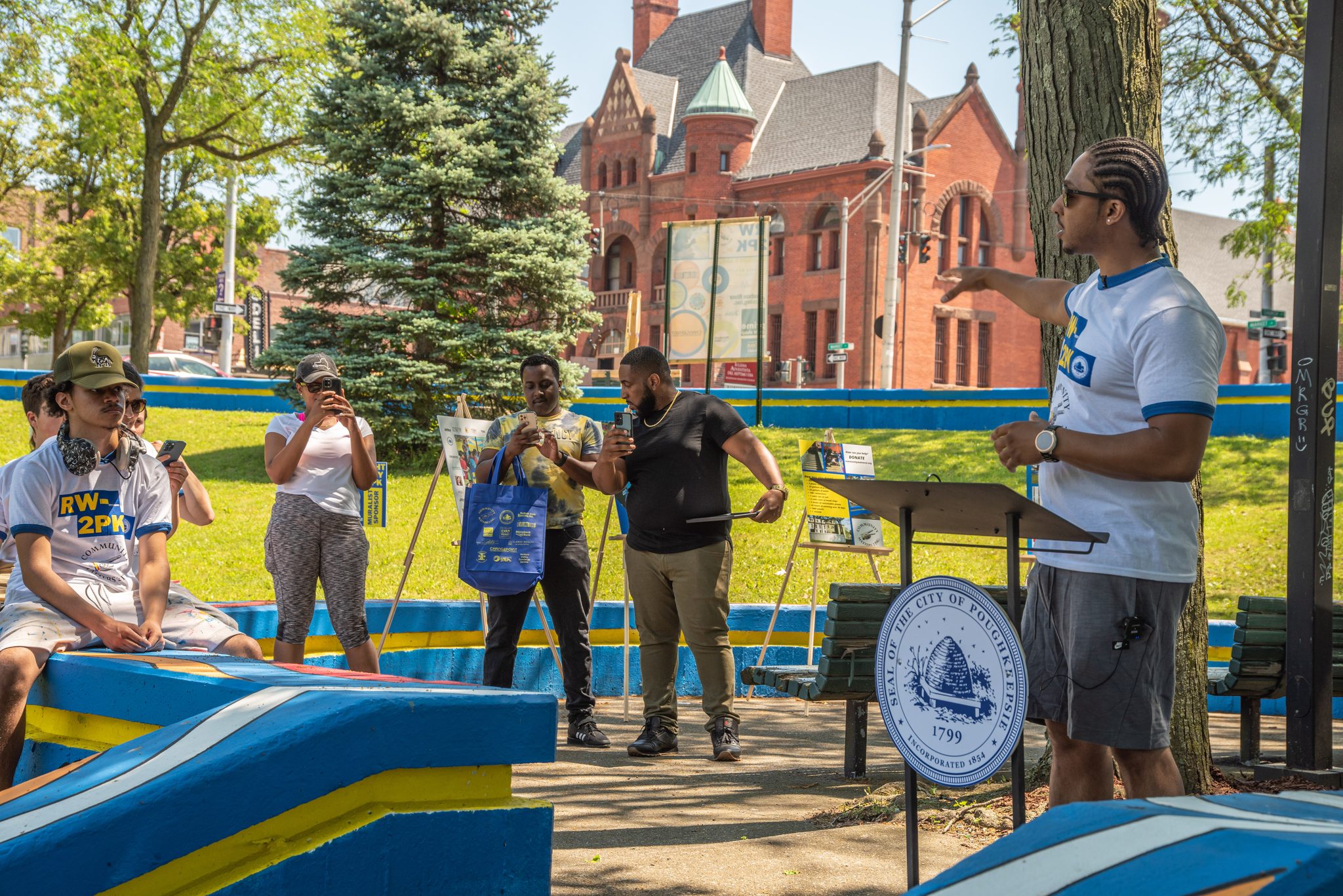 A speaker lifts an arm to the crowd at the park's dedication.
