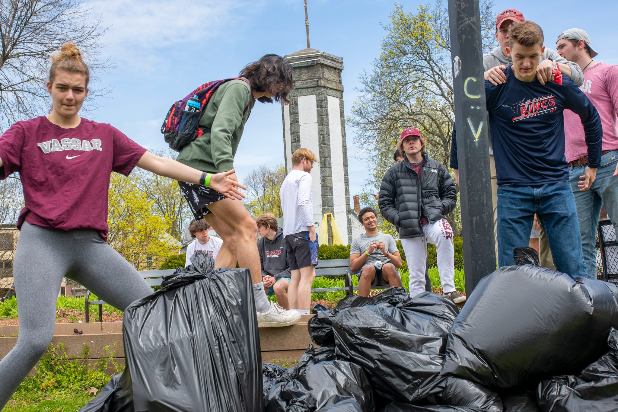 College volunteers pile their bags beneath the clock tower.