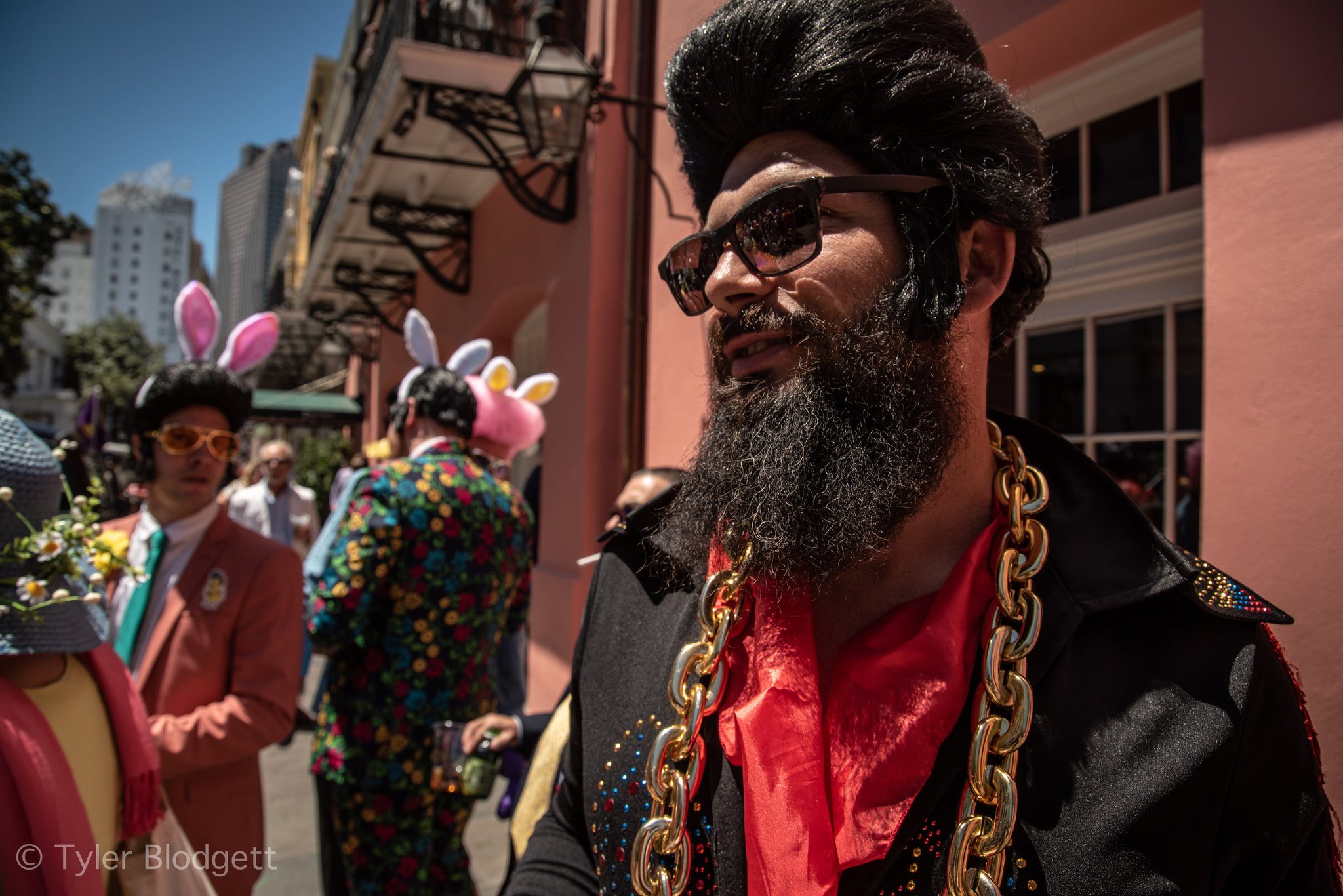 An Elvis in a pompadour and gold chains leads the way, bunny ears bobbing all around him.