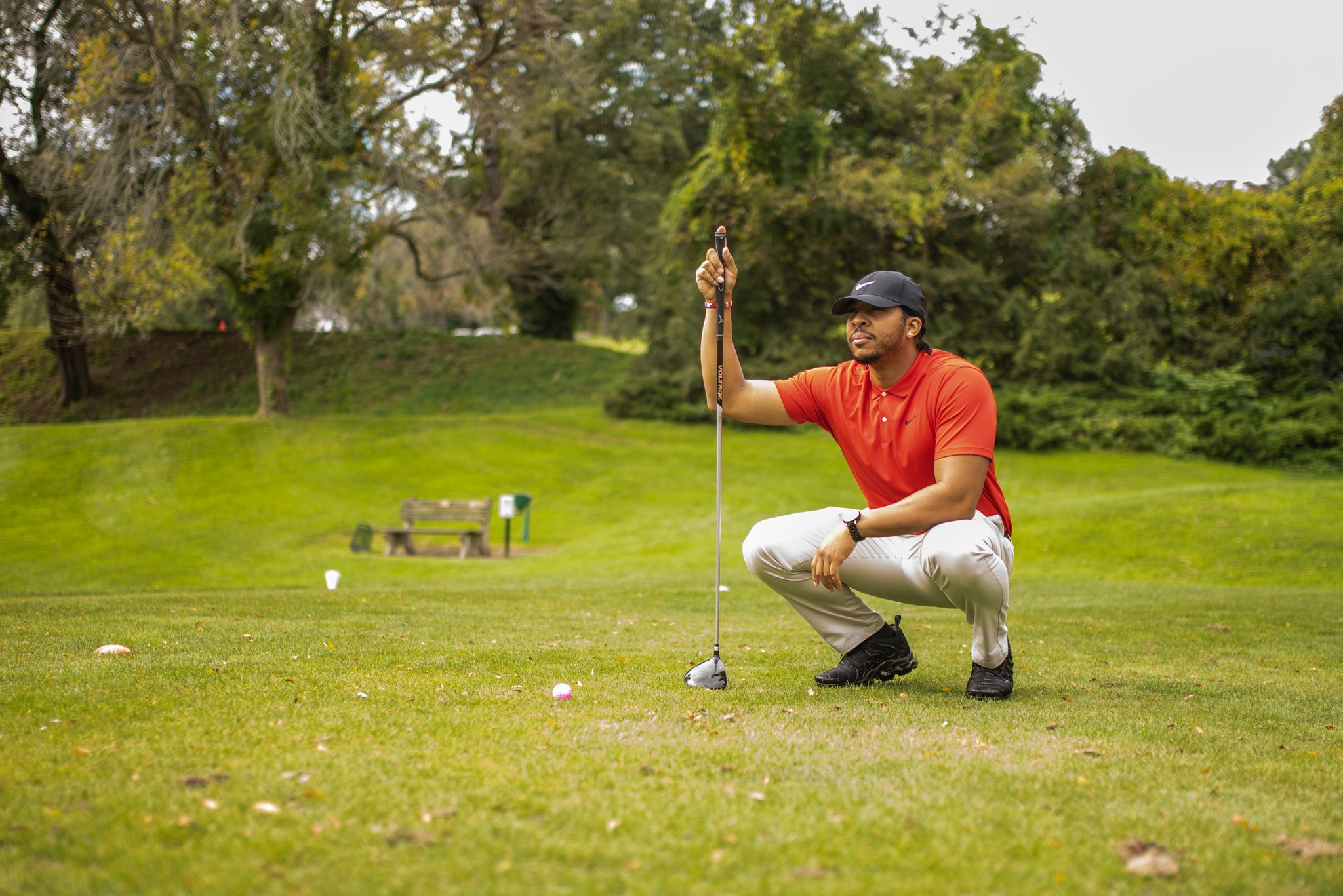 Crouched low, a golfer reads the green.