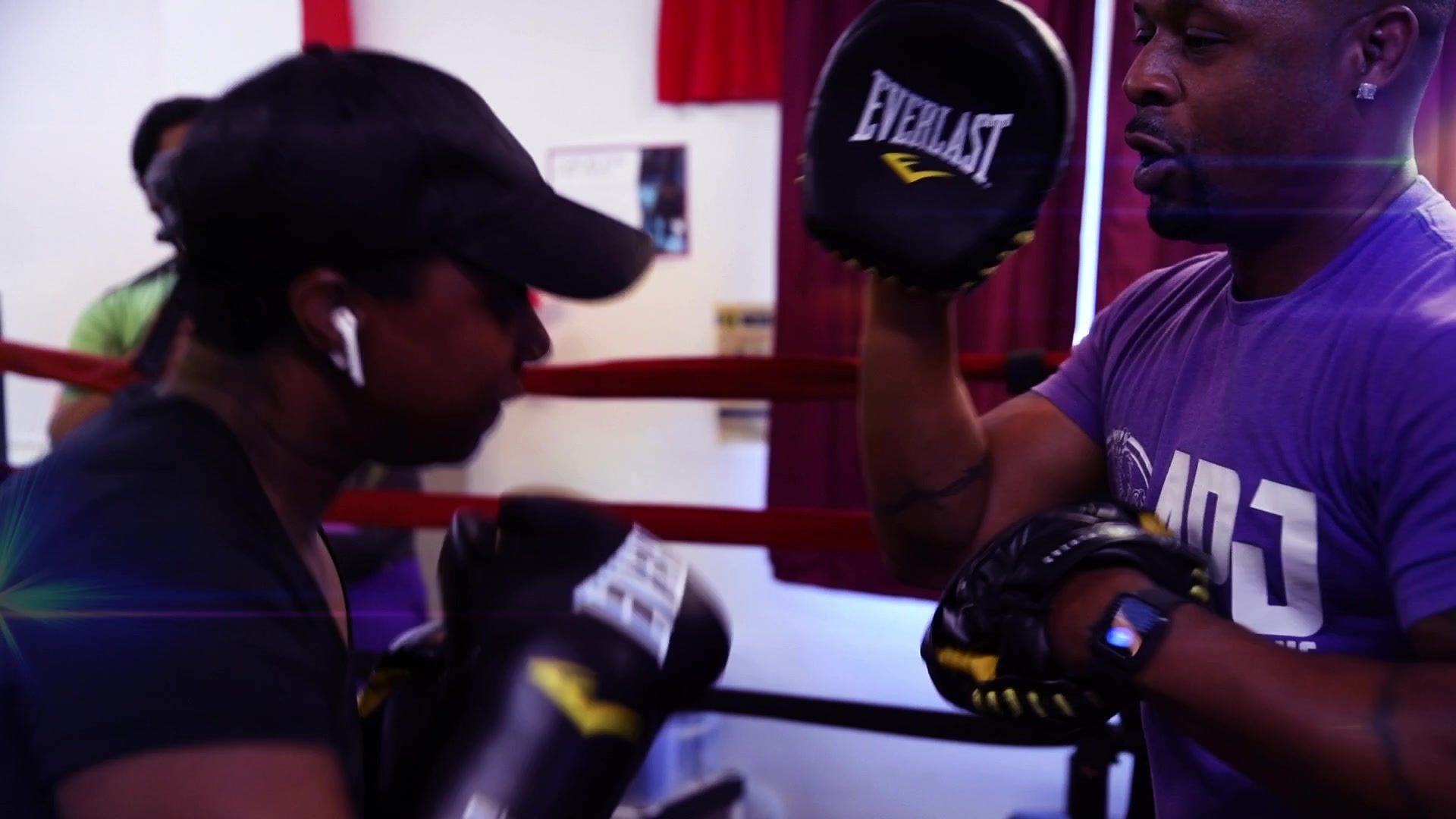 Mitt work at the ropes, the coach calling combinations while the gloves snap into his pads.
