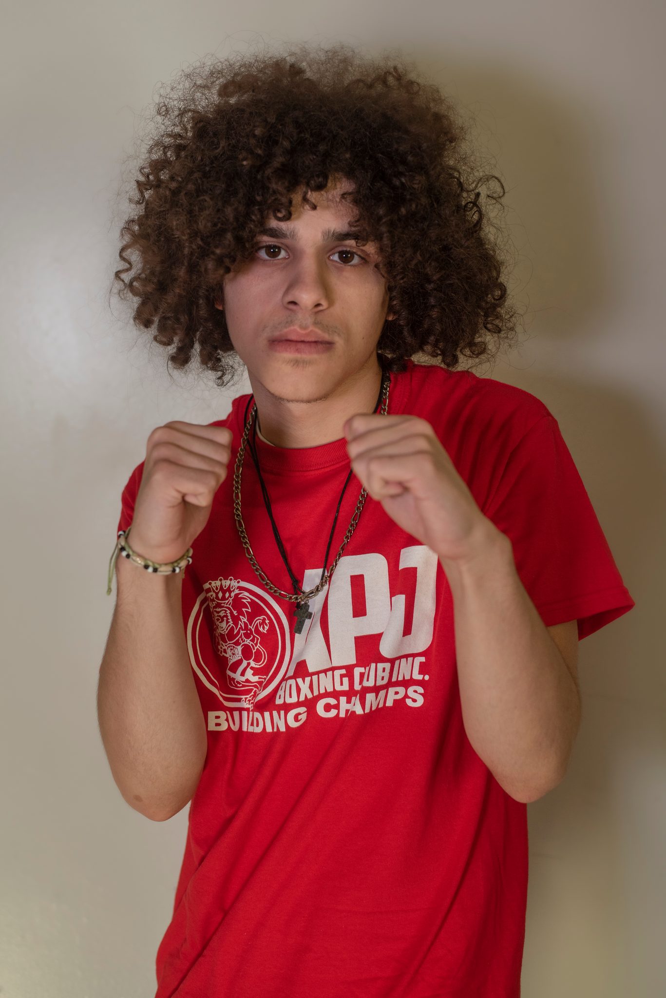 Fists up, a bracelet on his wrist.