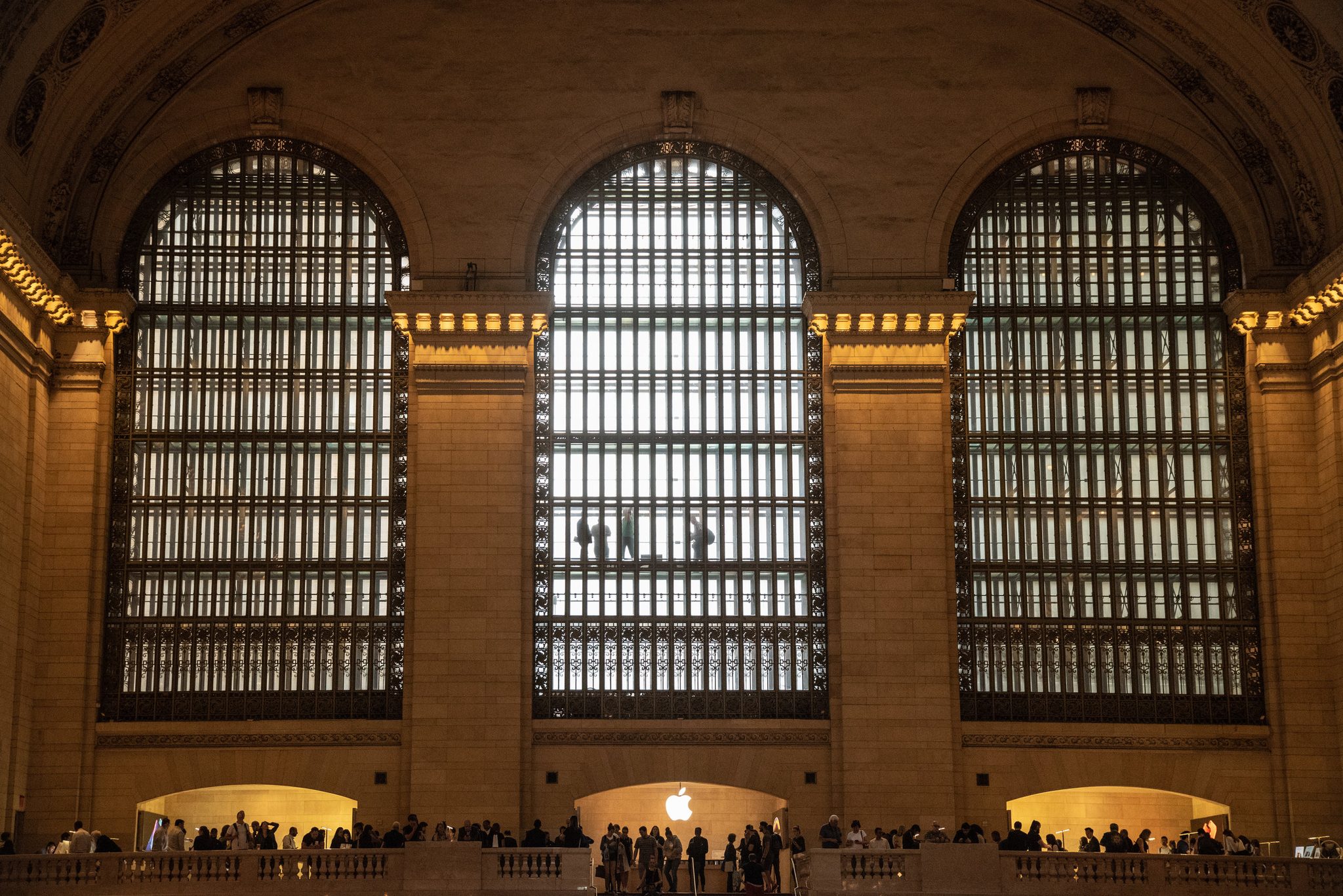 Grand Central's great windows pour light down onto the crowd along the balcony.