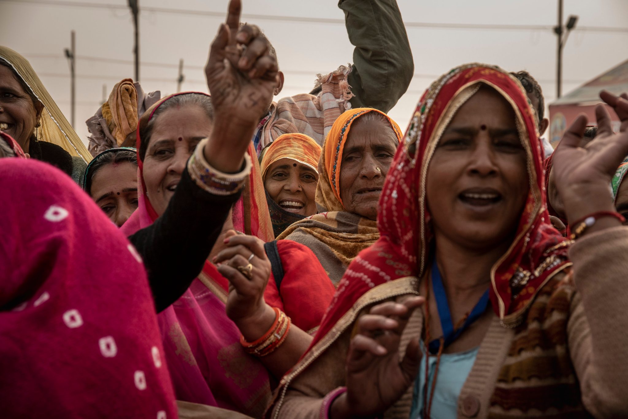 A group of women sing as they walk towards Sangam, the confluence of the holy rivers.