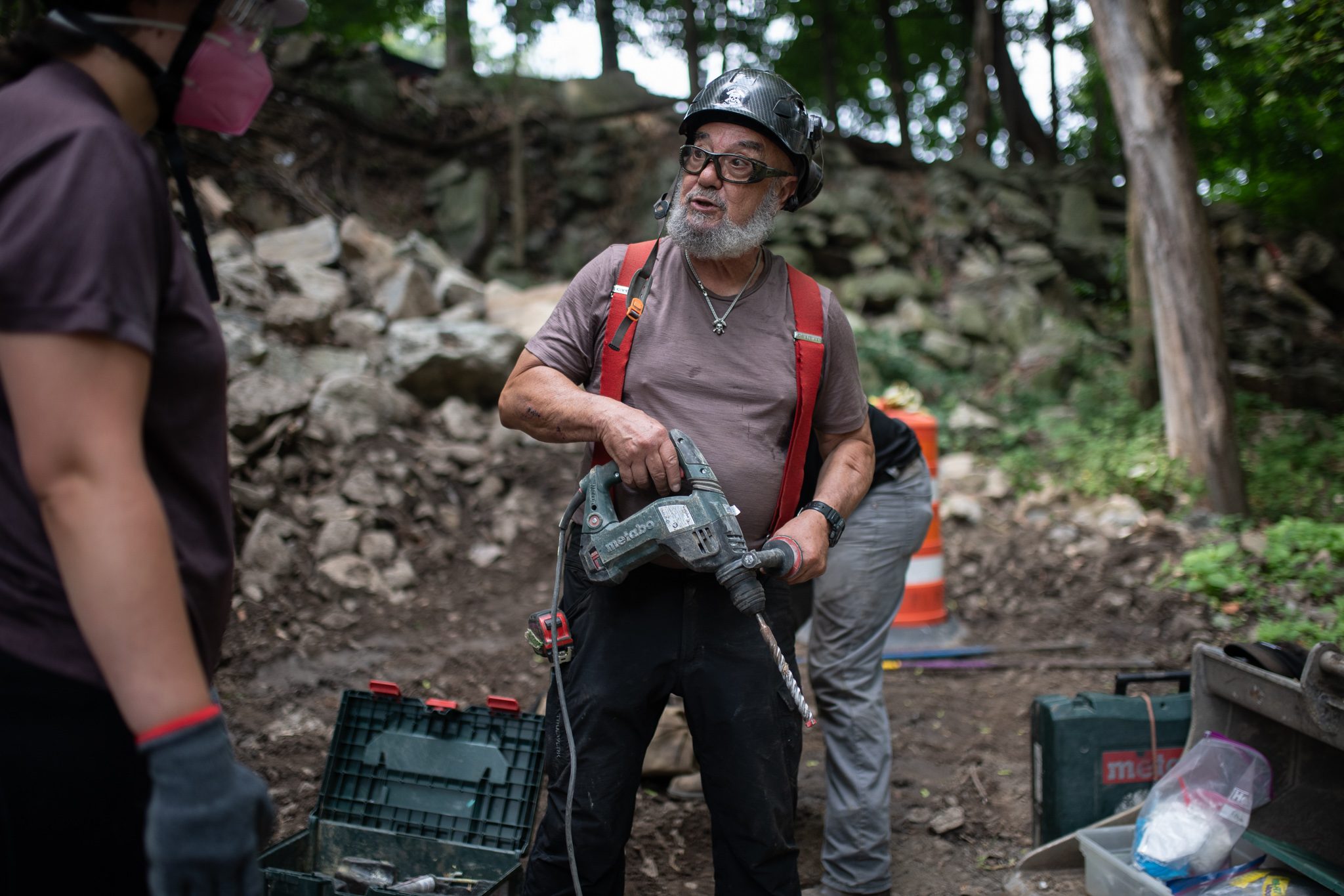The crew leader holds the rotary hammer at the ready.
