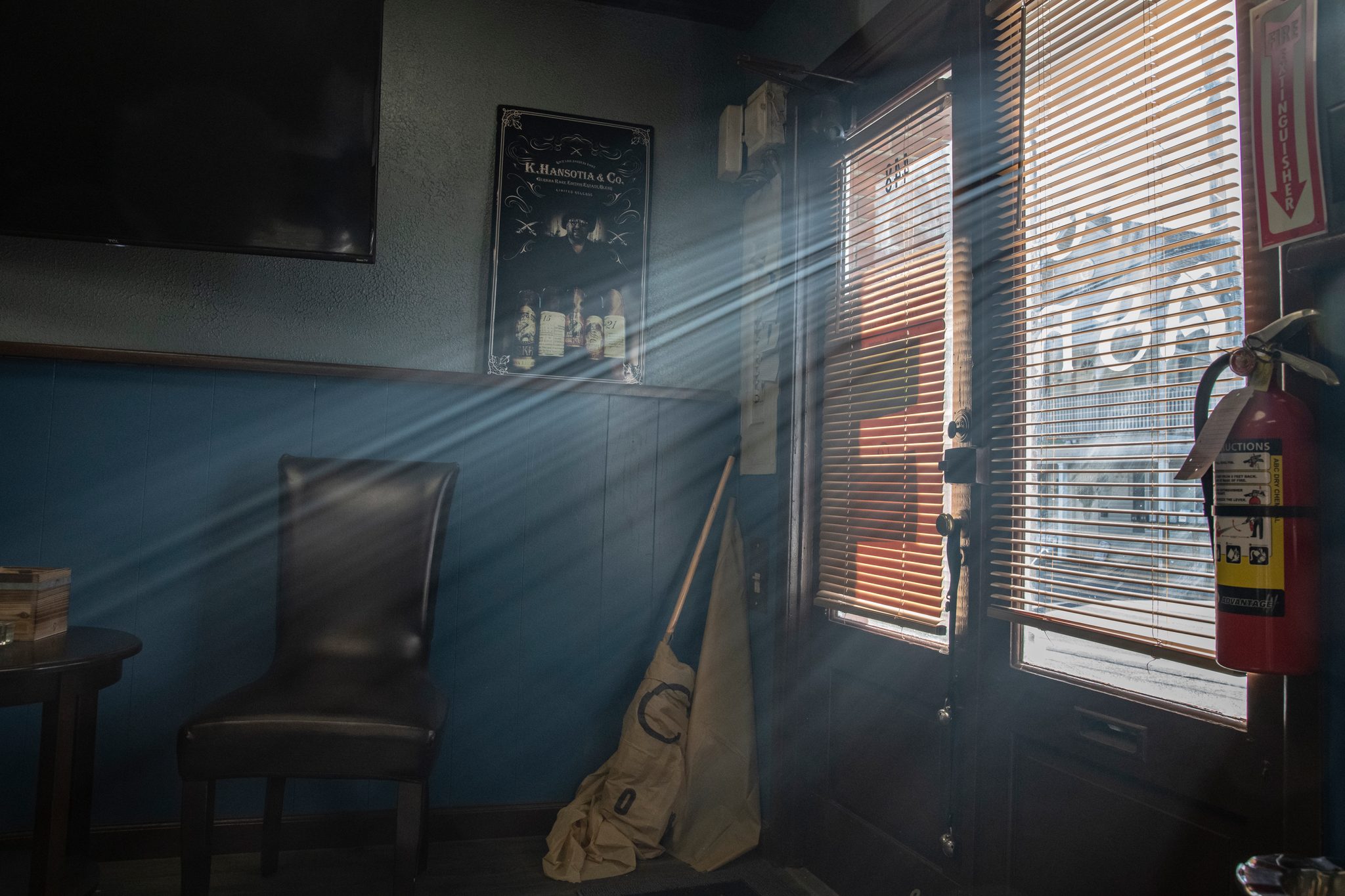 Afternoon light cuts through the blinds into the empty lounge.