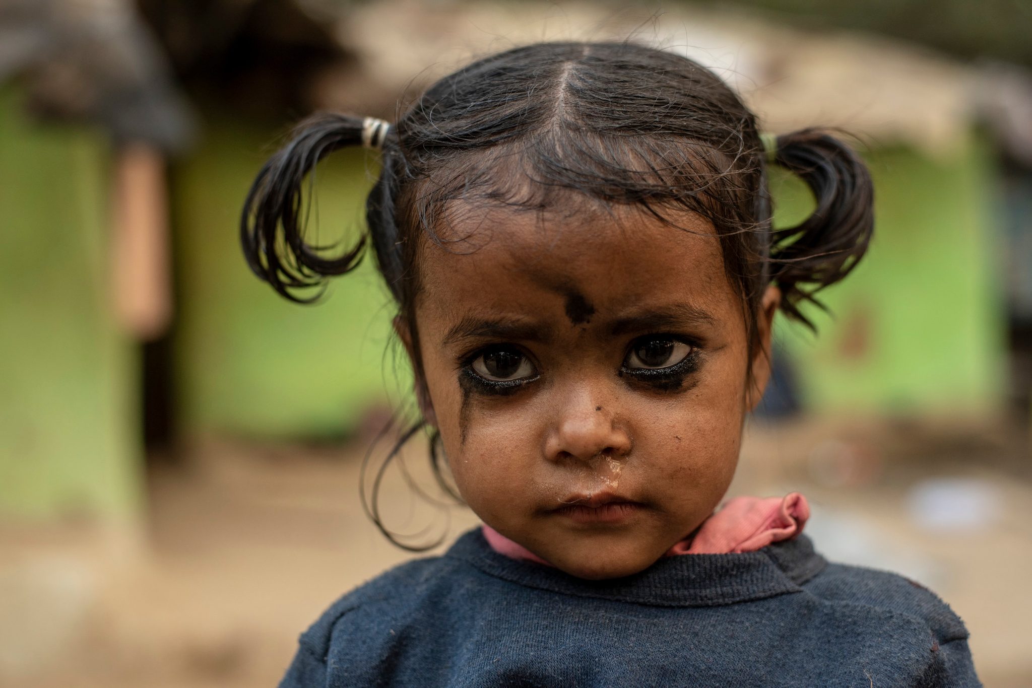 Little Chand who’s name means Moon in Hindi, stares intently with dark Kajal around her eyes.