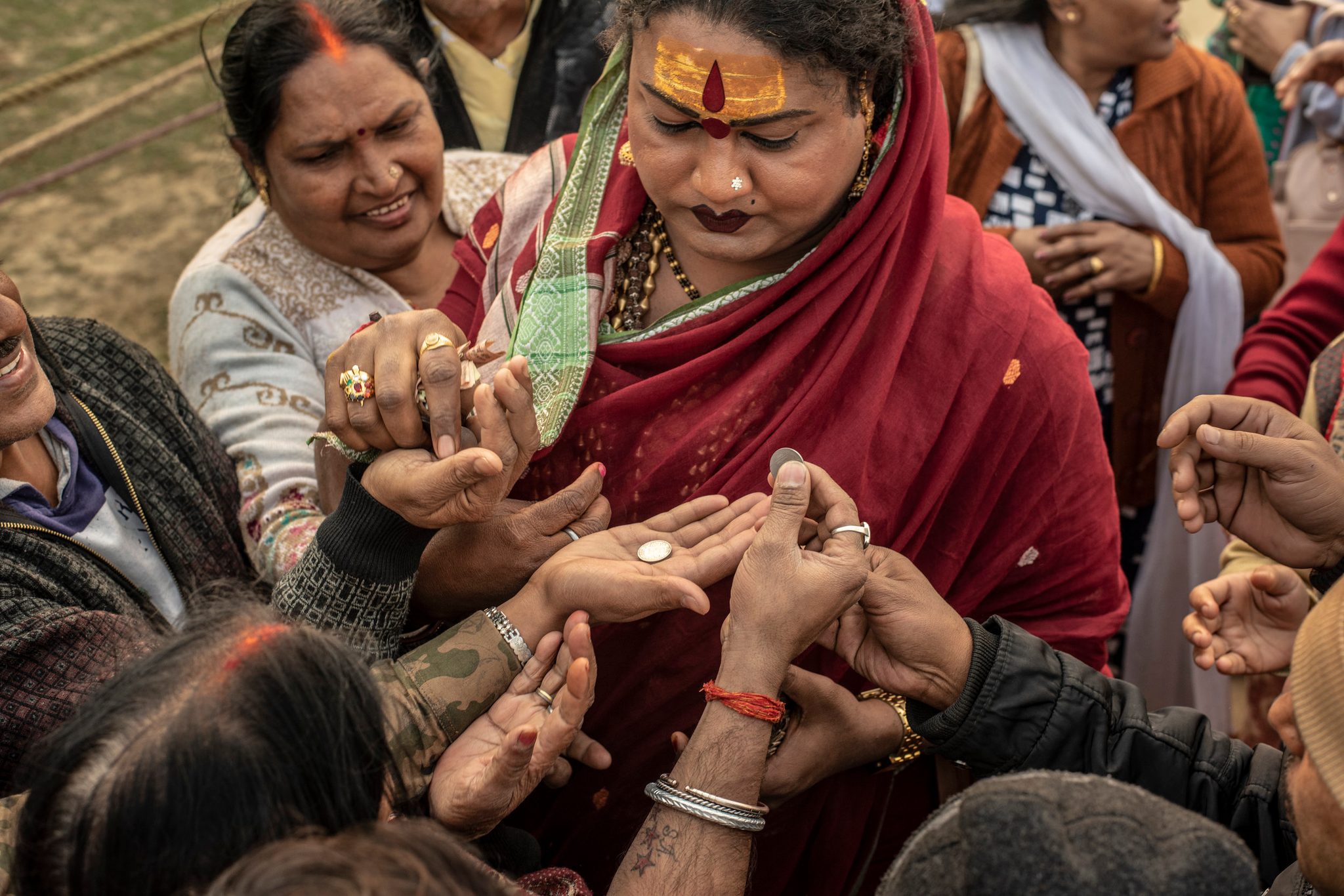 Mayuri Ma blesses coins and receives money offerings from followers.