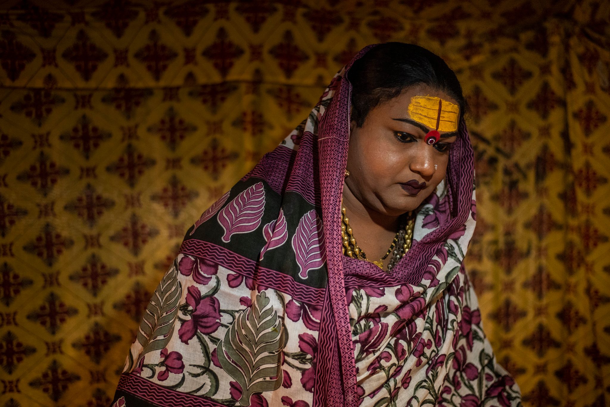 Mayuri Ma, a kinnar akada (transgender), prepares to leave her tent to give blessings to her followers.