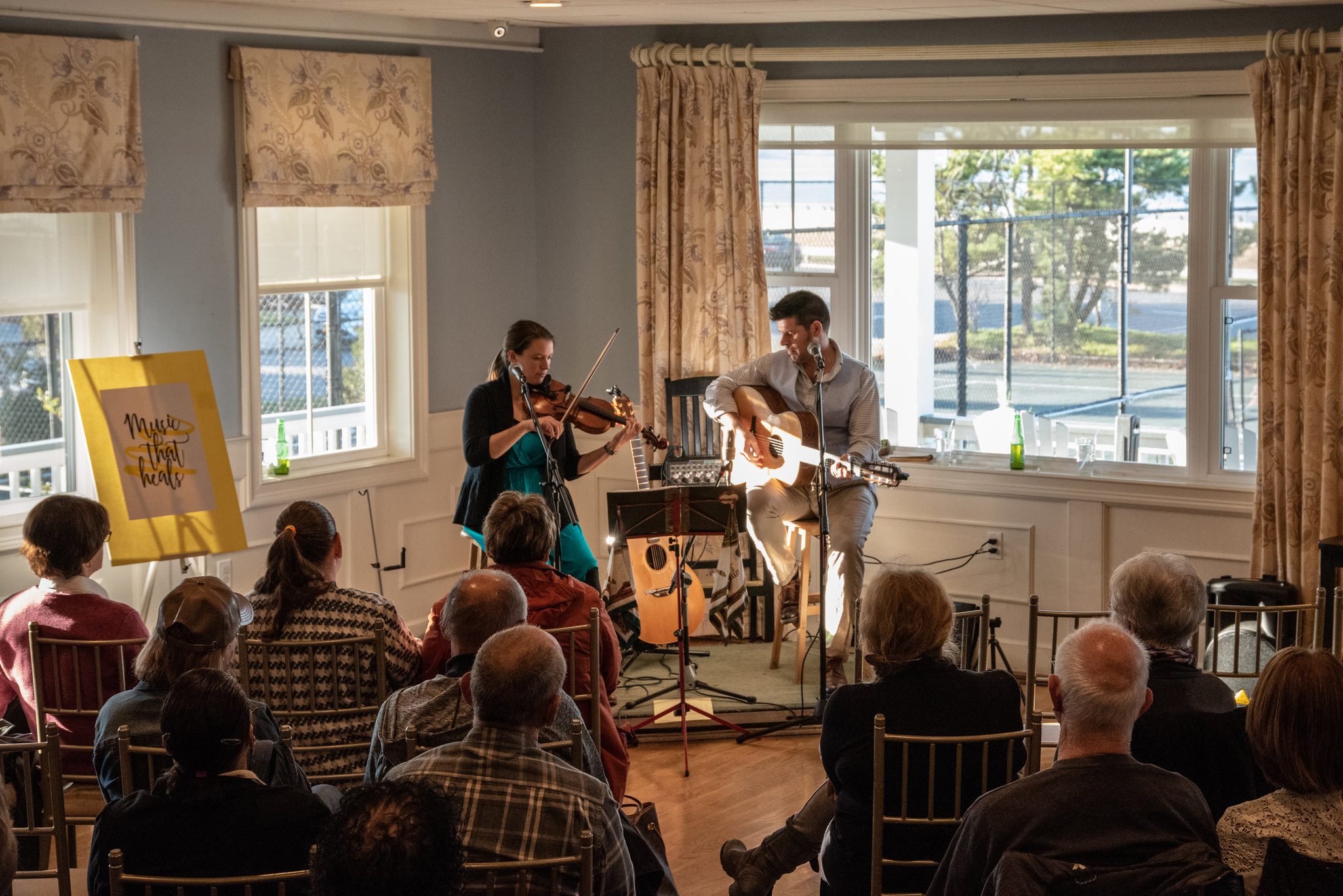 The house is packed to support Music That Heals, an organization The Poor Cousins are associated with that brings musicians into hospitals to play music for the terminally ill.