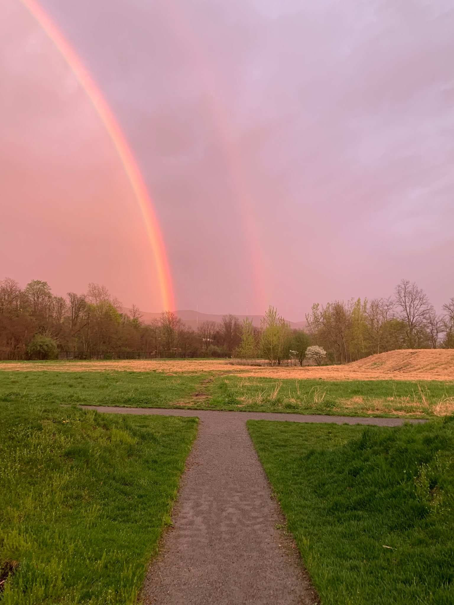 A double rainbow over the riverside park after the rain.