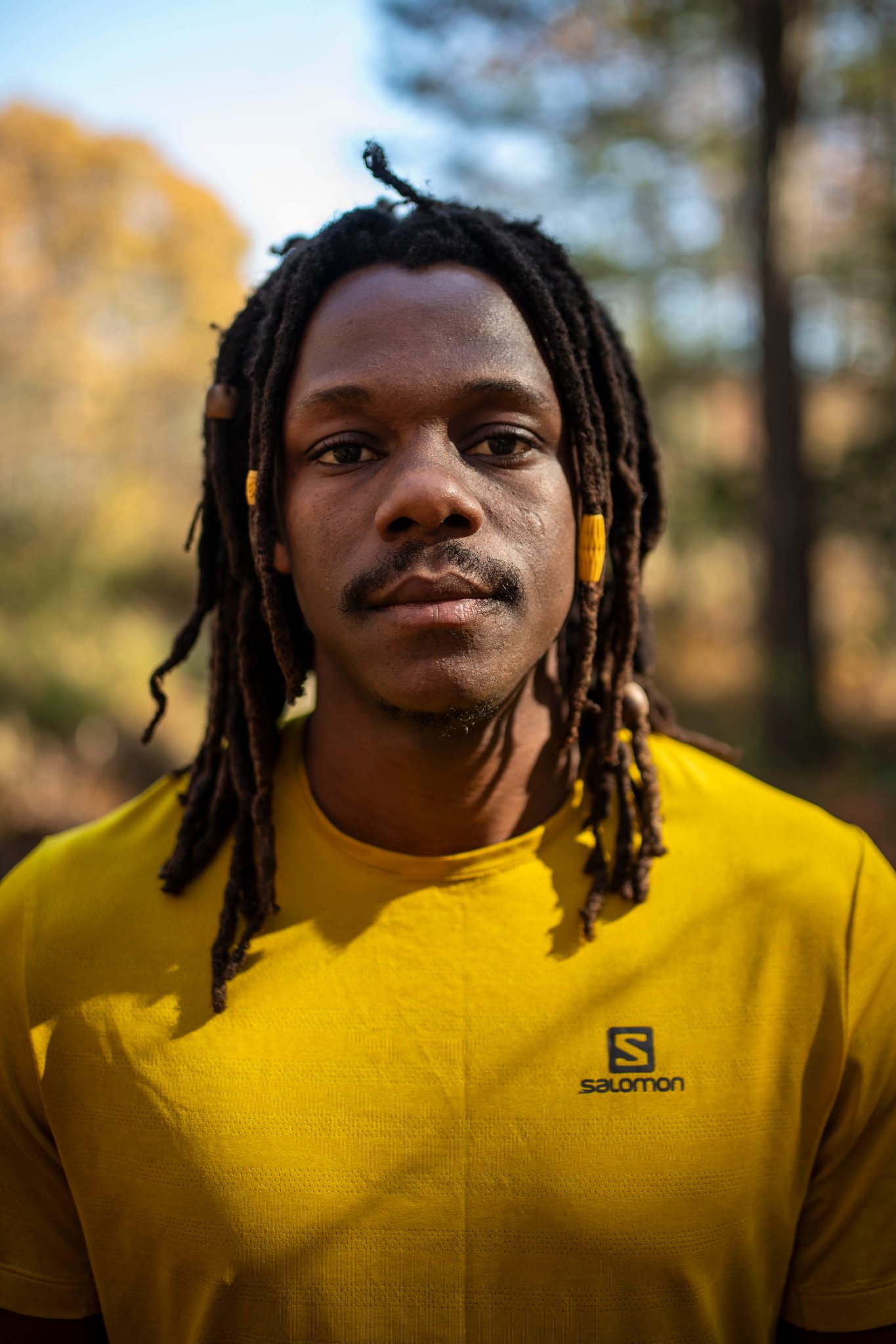 Close and direct: Chev looks into the lens, the forest soft and golden behind him.