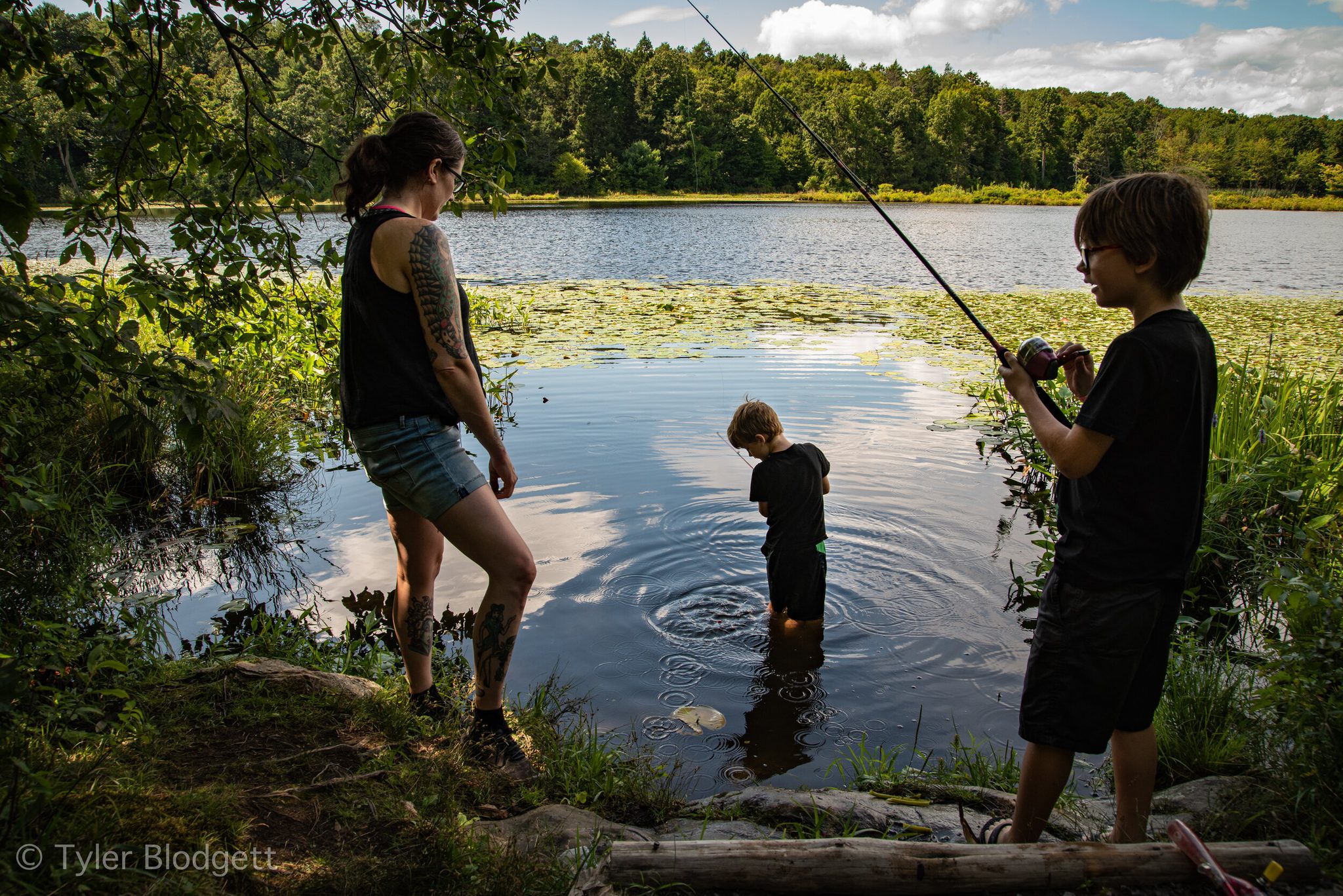At the water's edge, a fishing line goes out while the smallest wades in to see what's there.