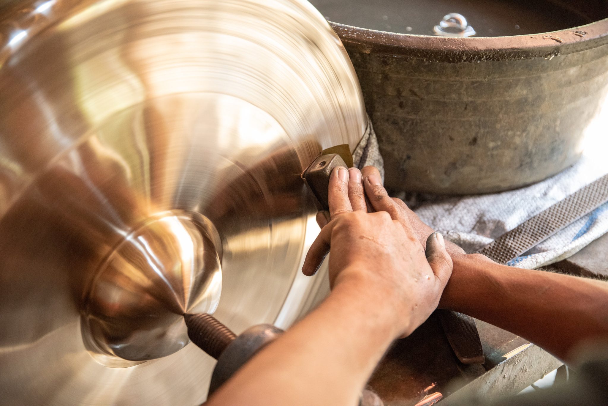 Large gamelan gong is carefully polished