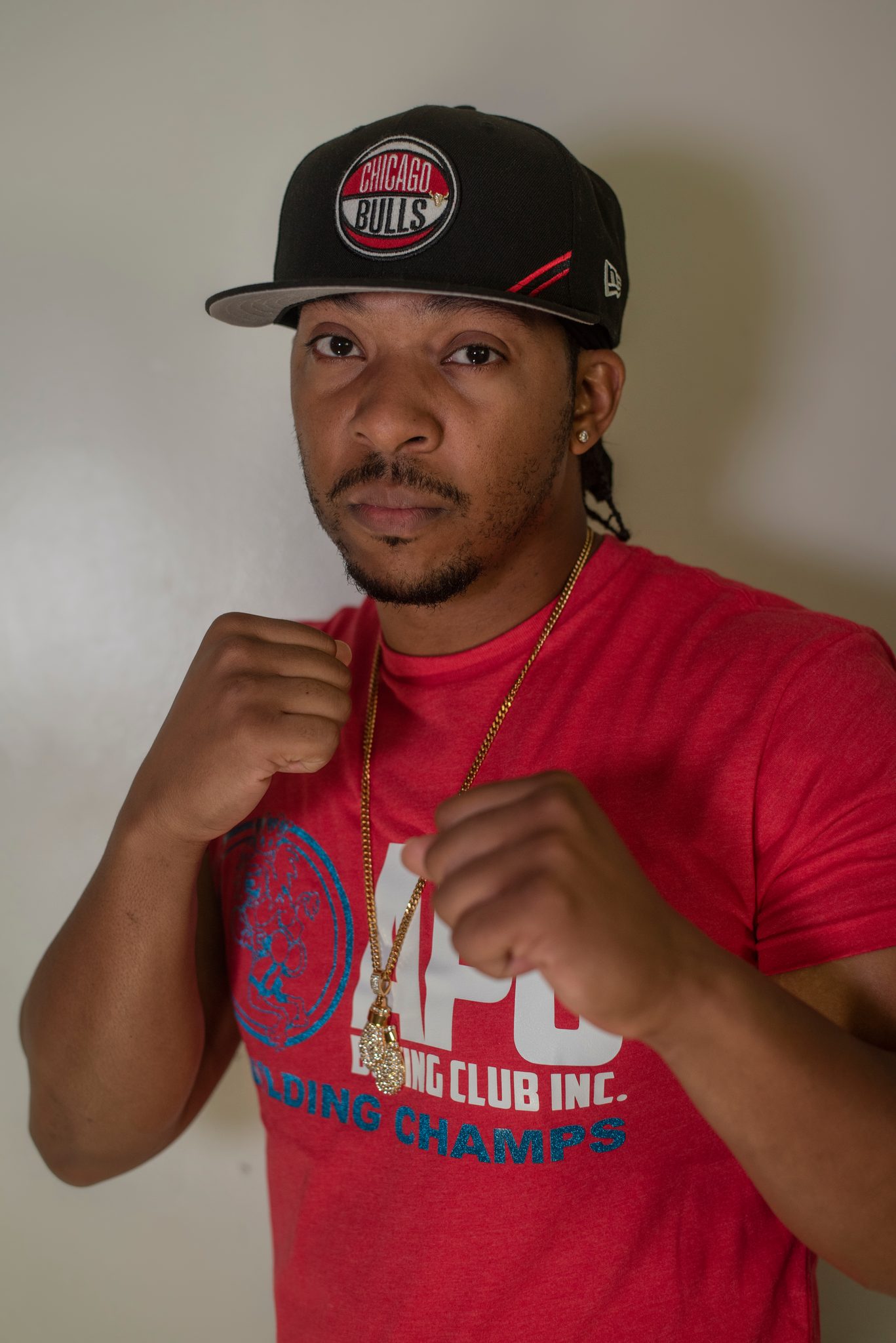 Cap low, fists up.