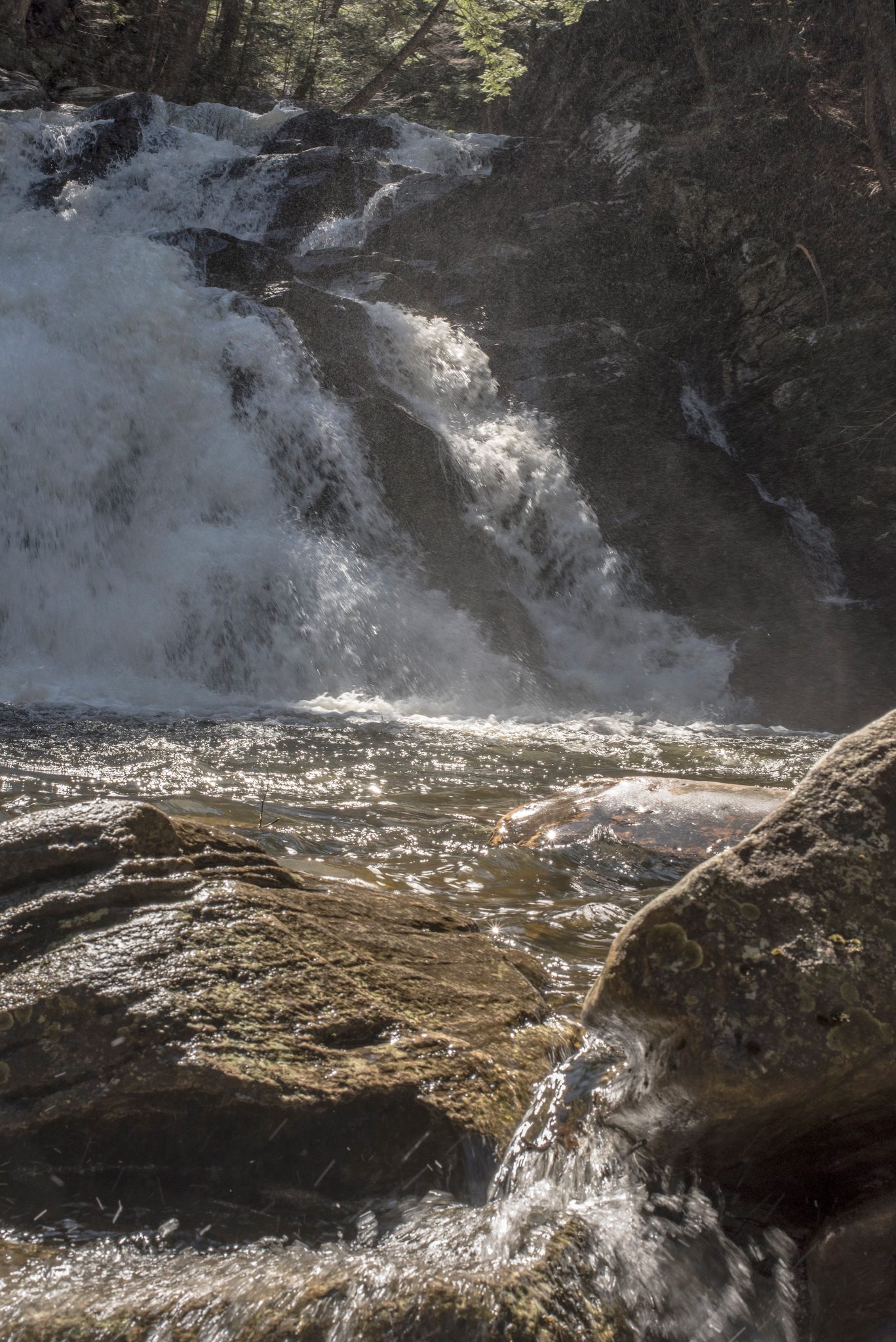 Water spills over the rocks and down the falls.