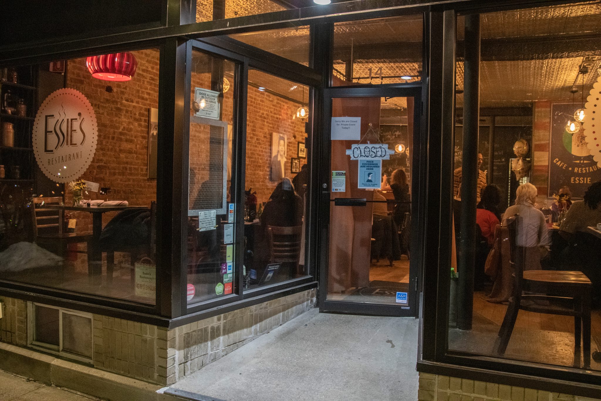 The restaurant glows through the glass on a winter night.