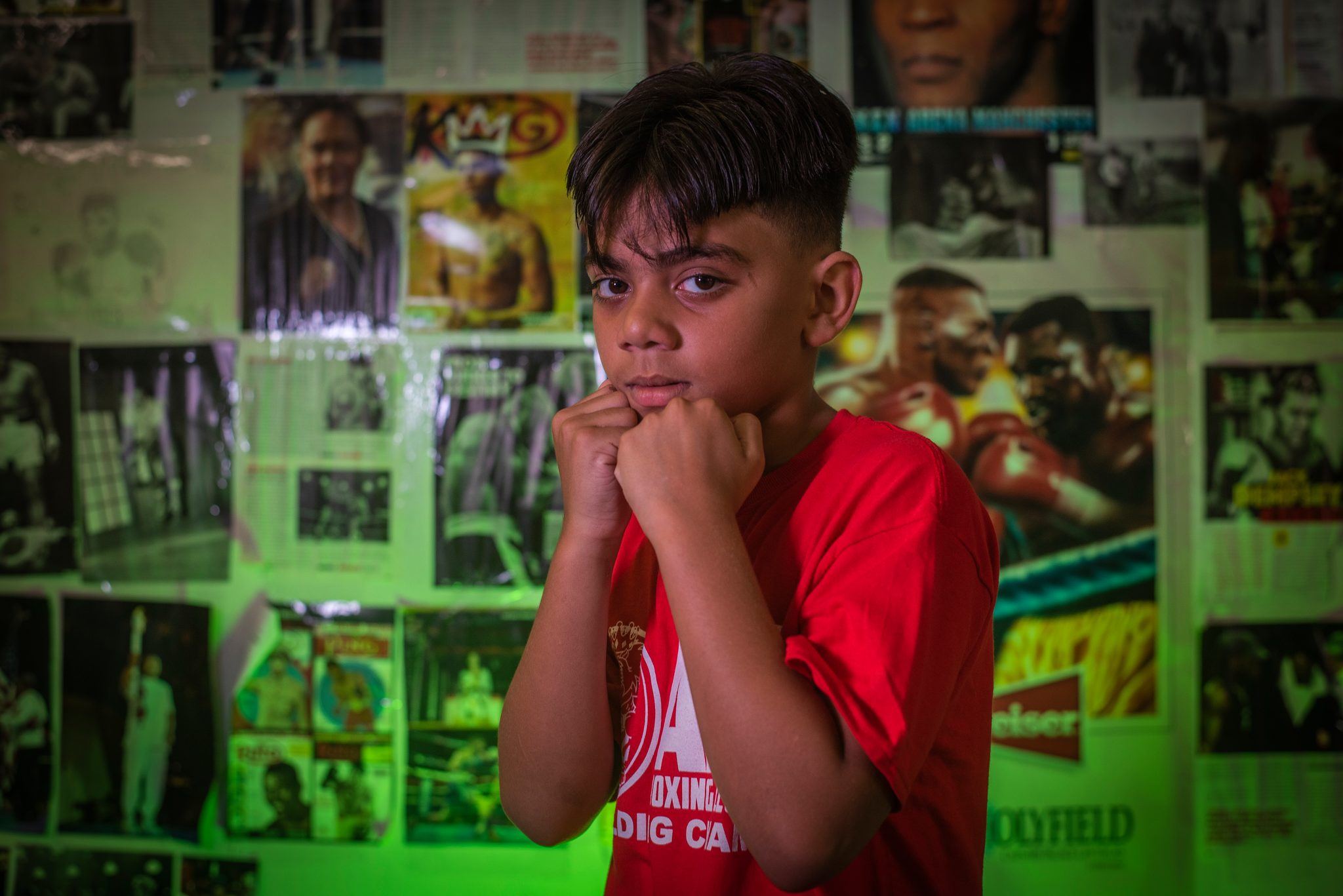 Fists pulled tight to his chin, eyes on the lens.