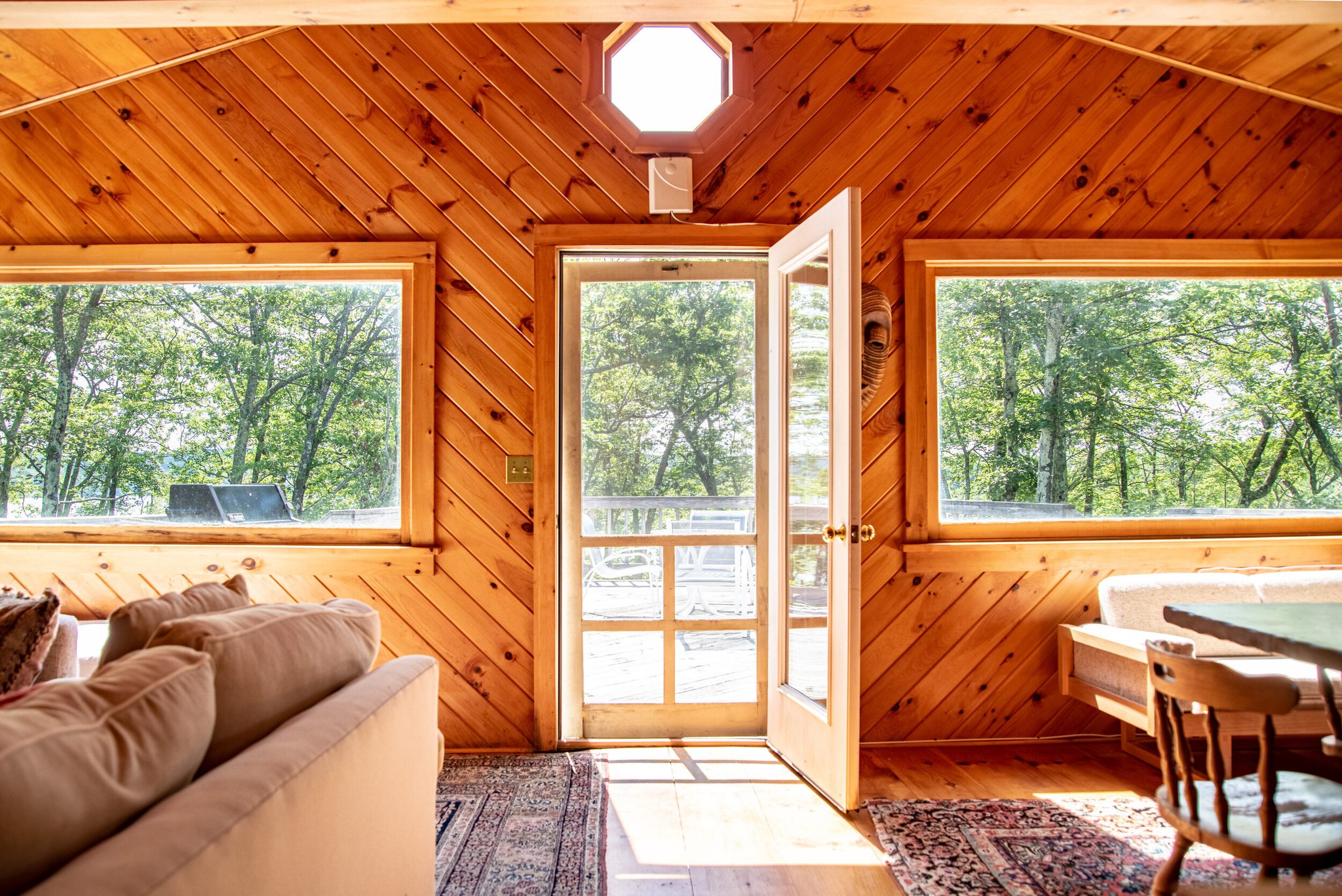 Knotty pine walls, an octagonal window and the lake light pouring through the open door.