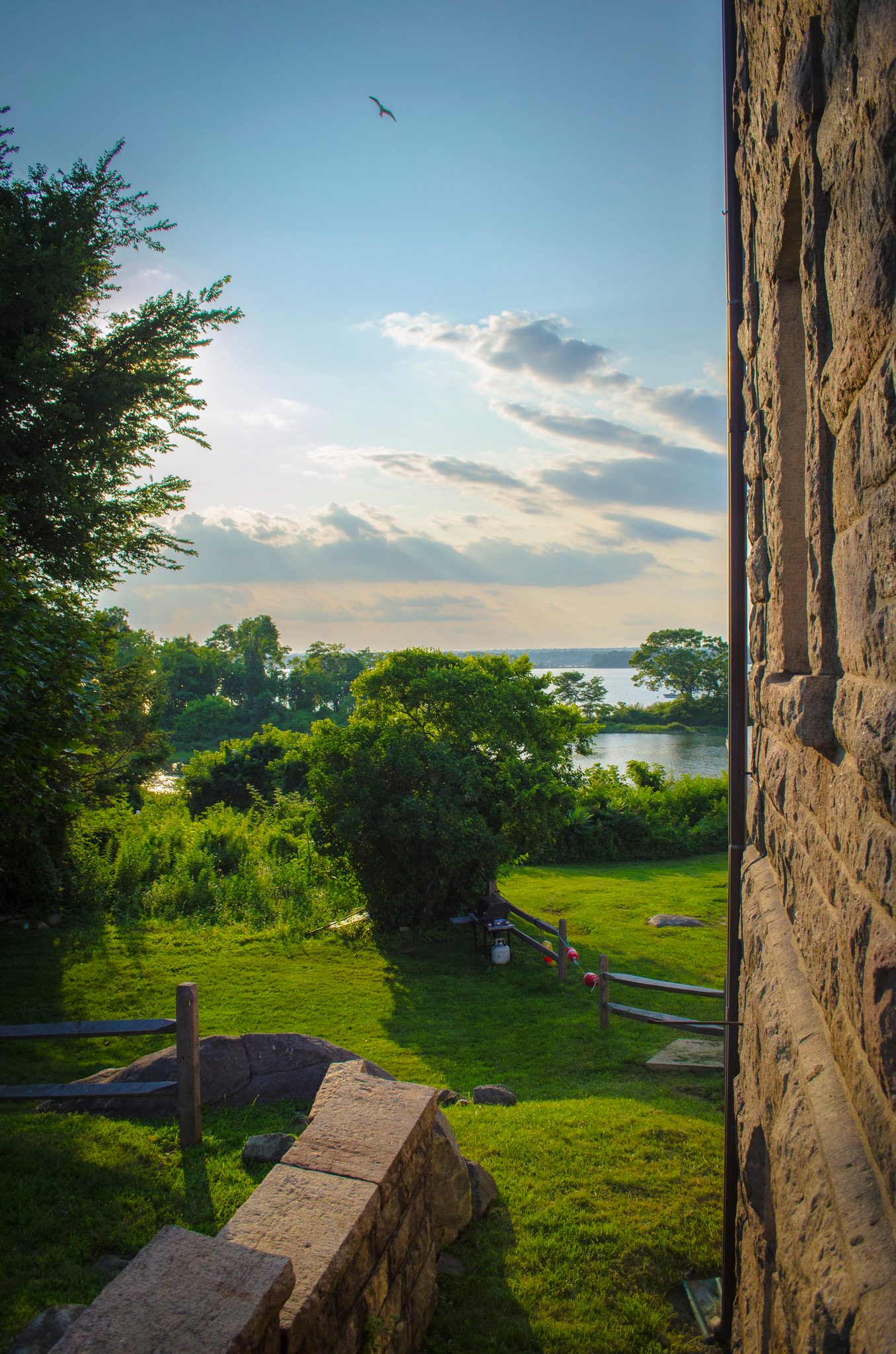 Through a stone archway, the cove opens up in green and blue.