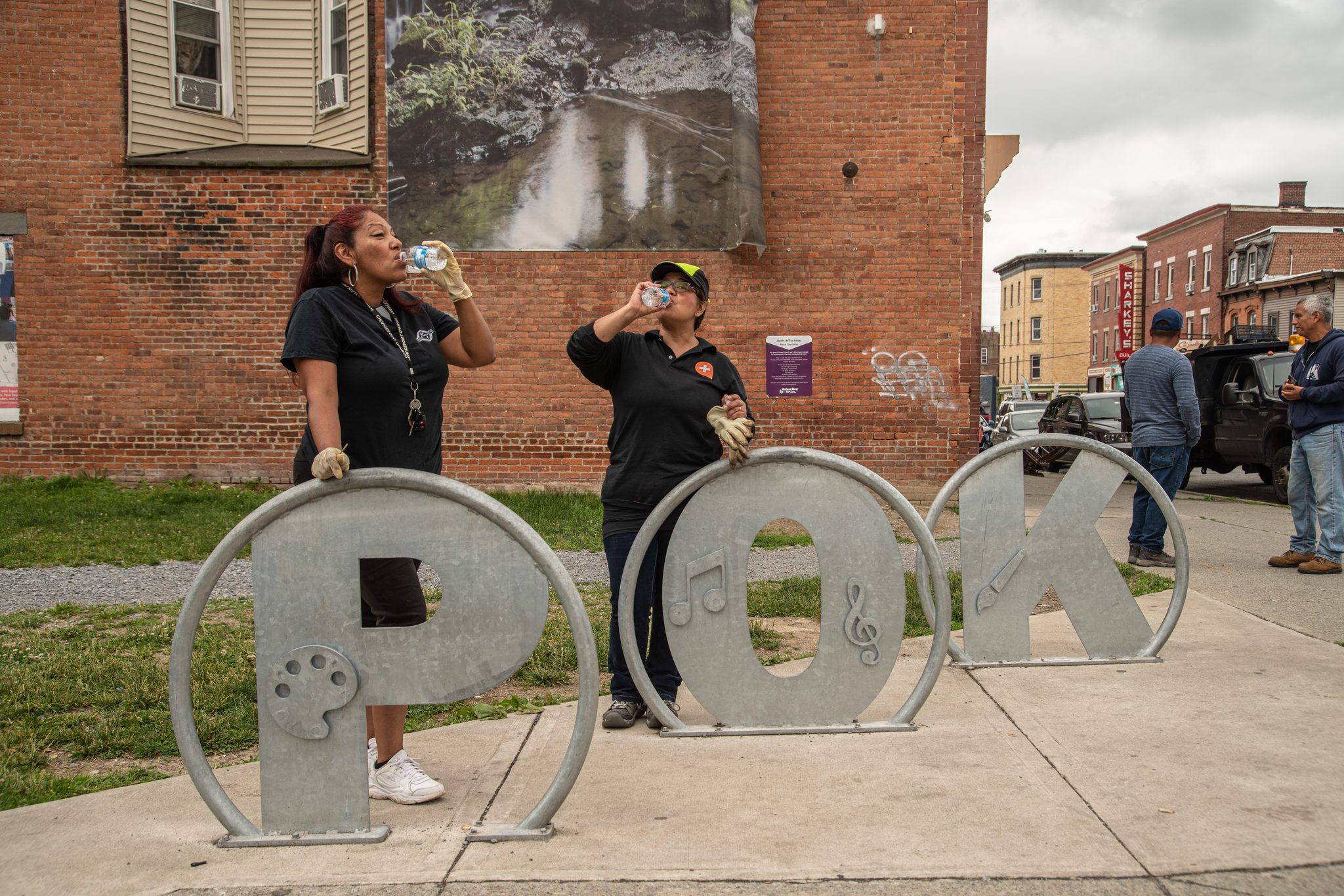 Volunteers spread out behind the big POK letters.
