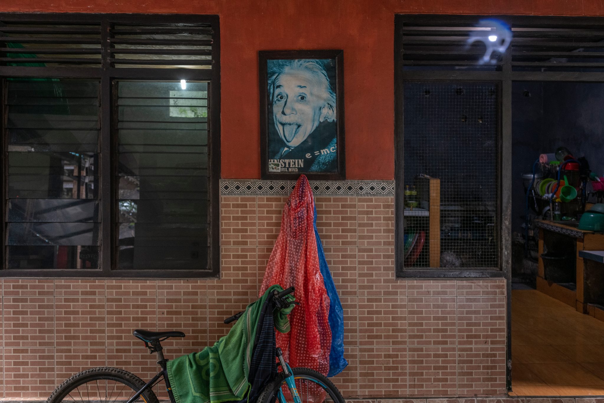 Einstein sticks out his tongue from a poster over the doorway.