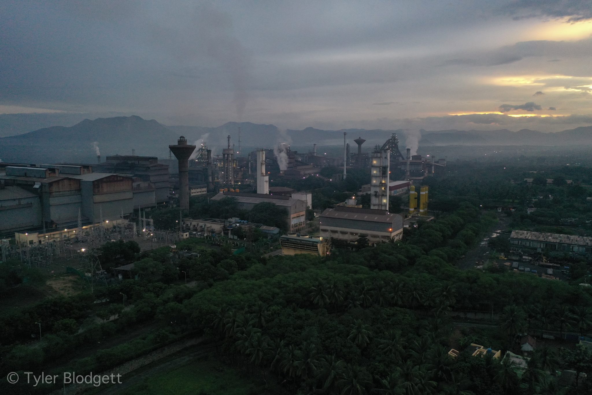 Smokestacks rise from the mill as dawn breaks over the plain.