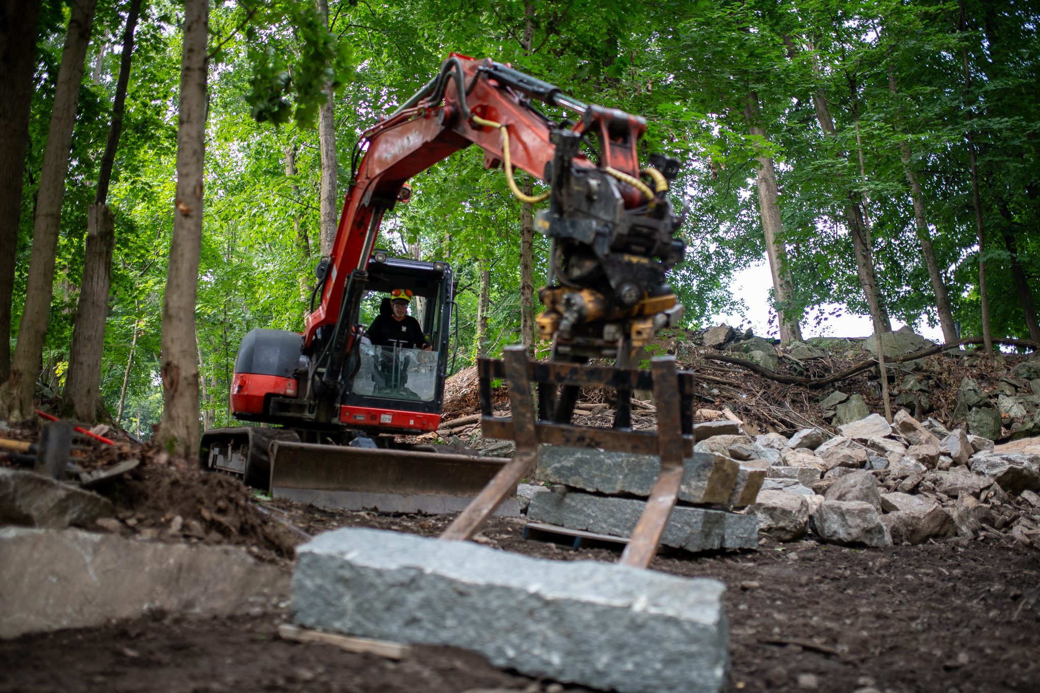 A single block swings in the grapple on its way down the slope.