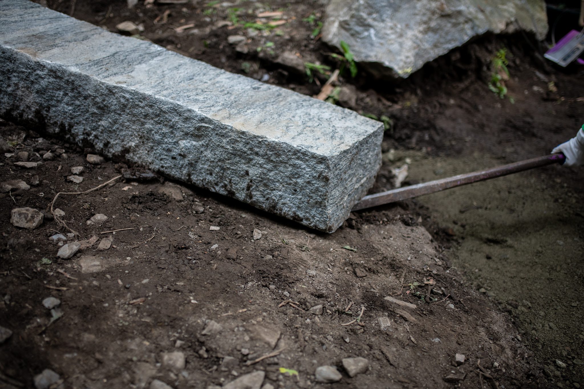 A bar slides under the edge of a granite step.