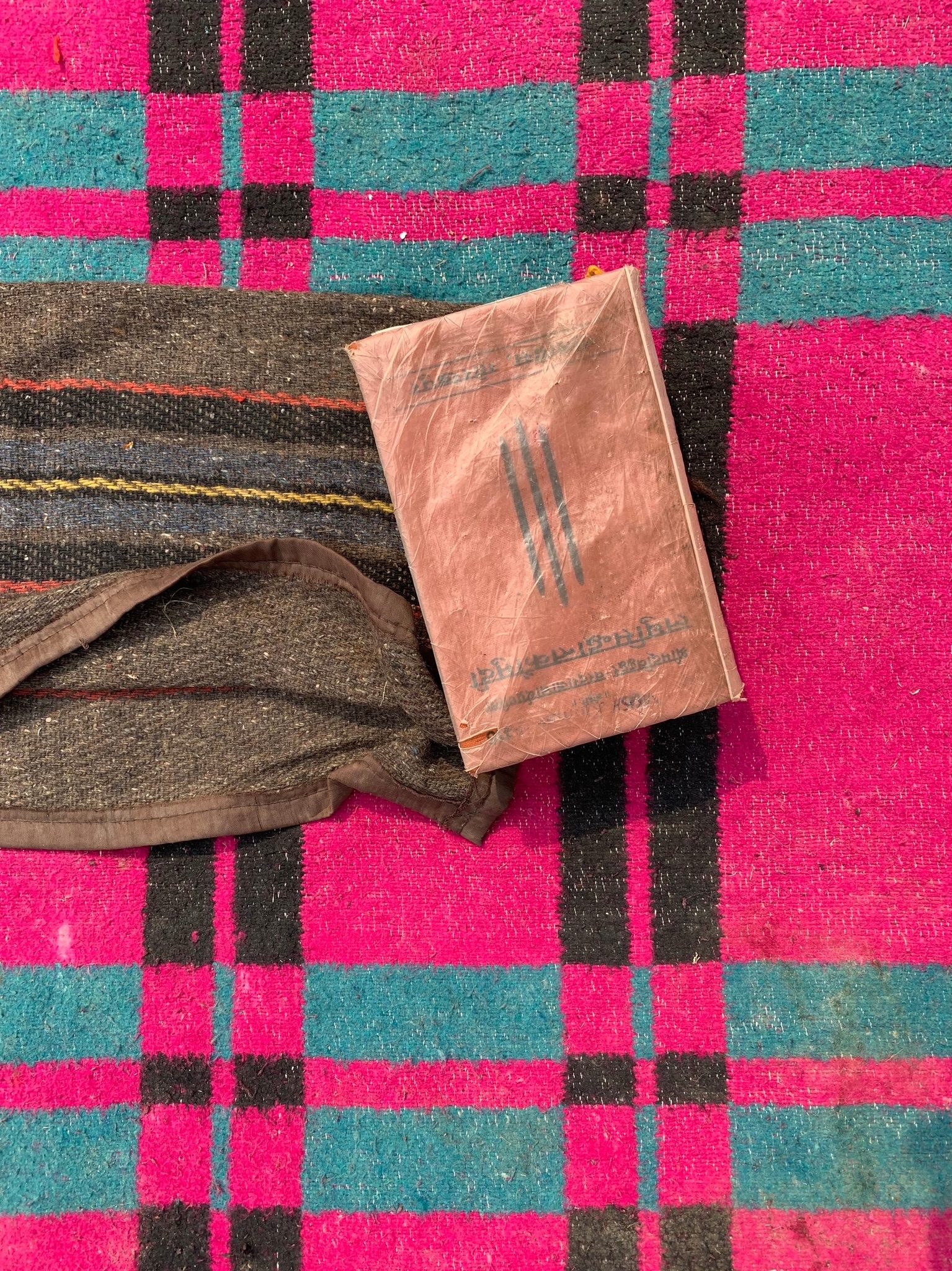 Vedic text sits on a novice monk’s vibrant blanket