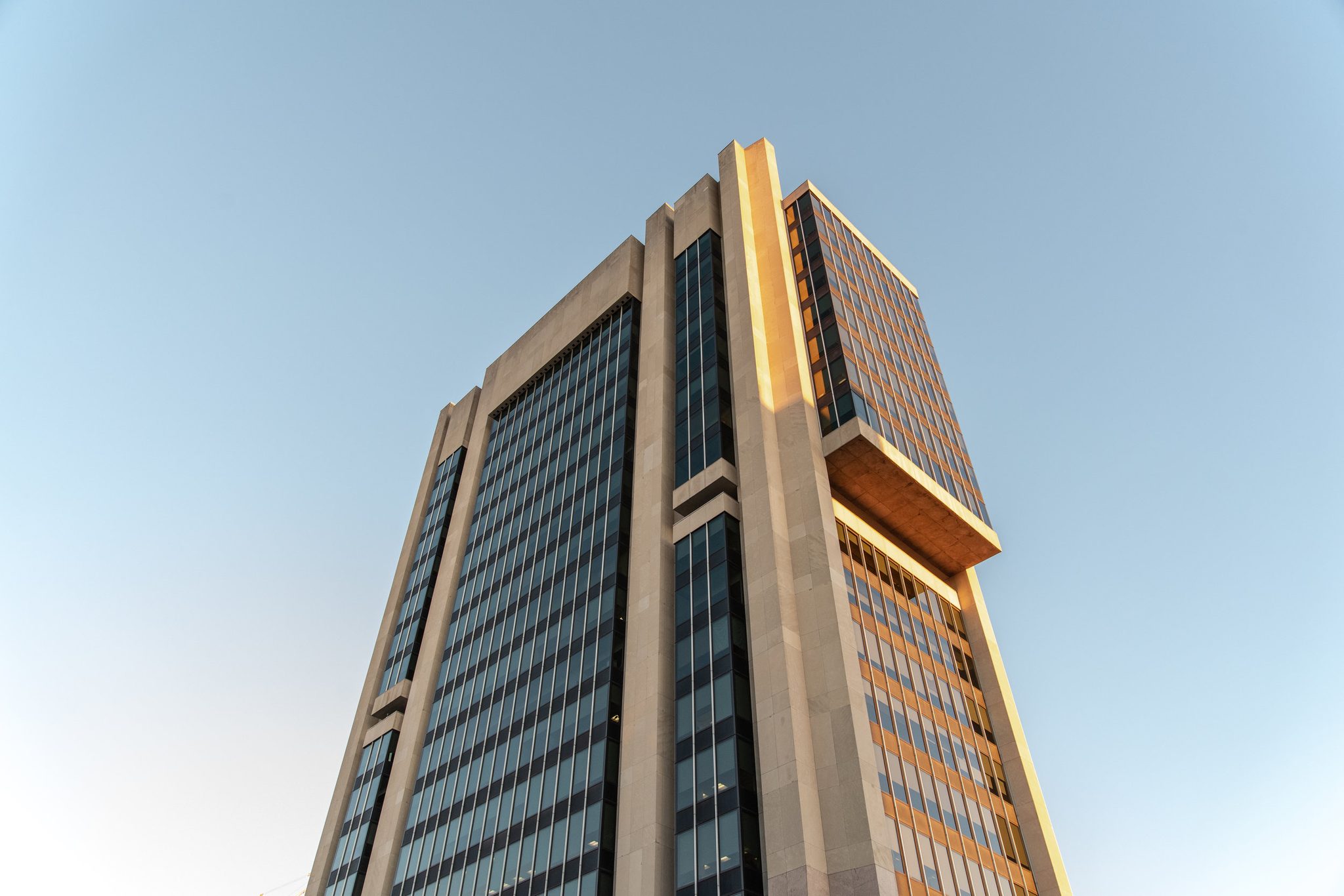 A tower catches the last warm light against a clean blue sky.