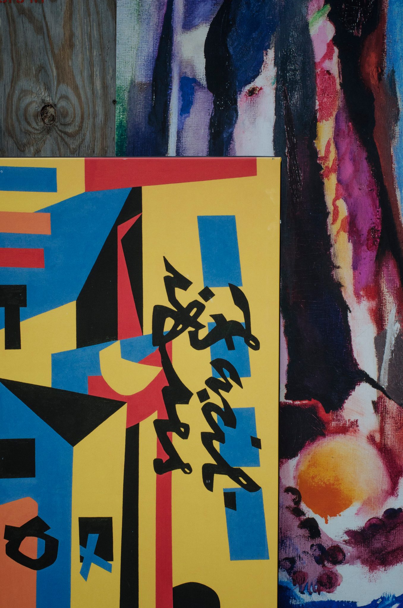 Bold color and brushstrokes layered on a painted wall.