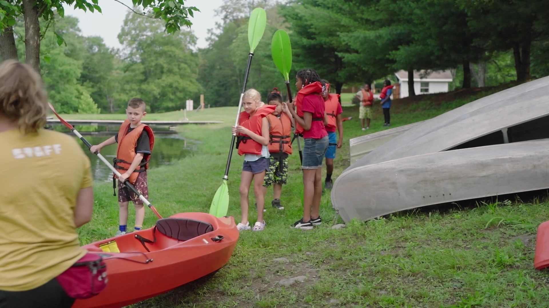 Life jackets on and paddles up, the campers head for the kayaks.