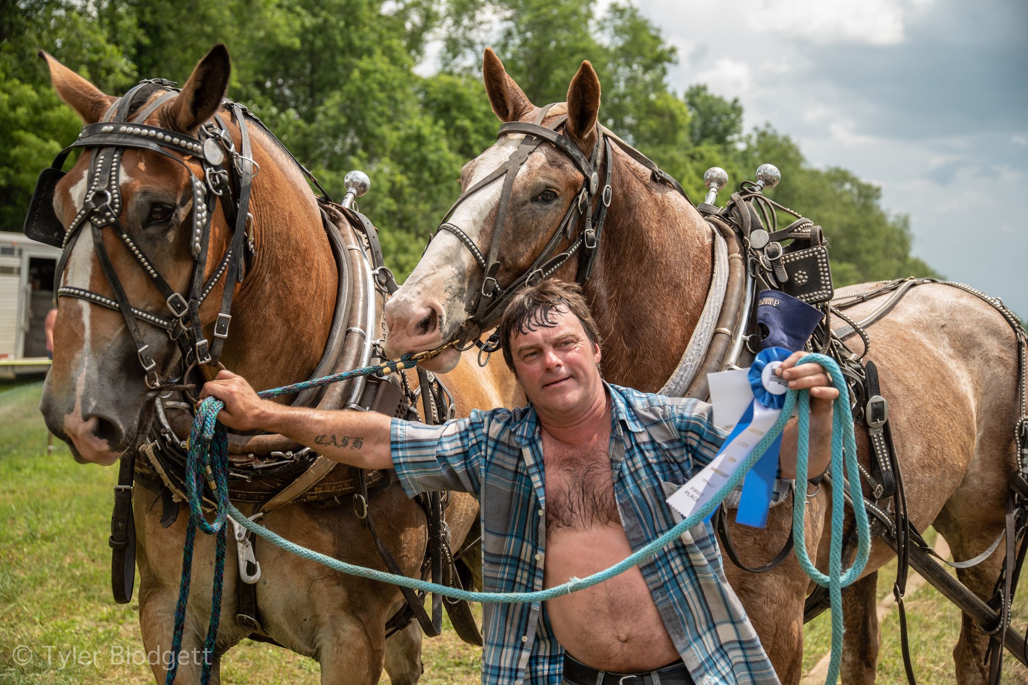 Blue ribbon in hand, a teamster stands with the pair that earned it.