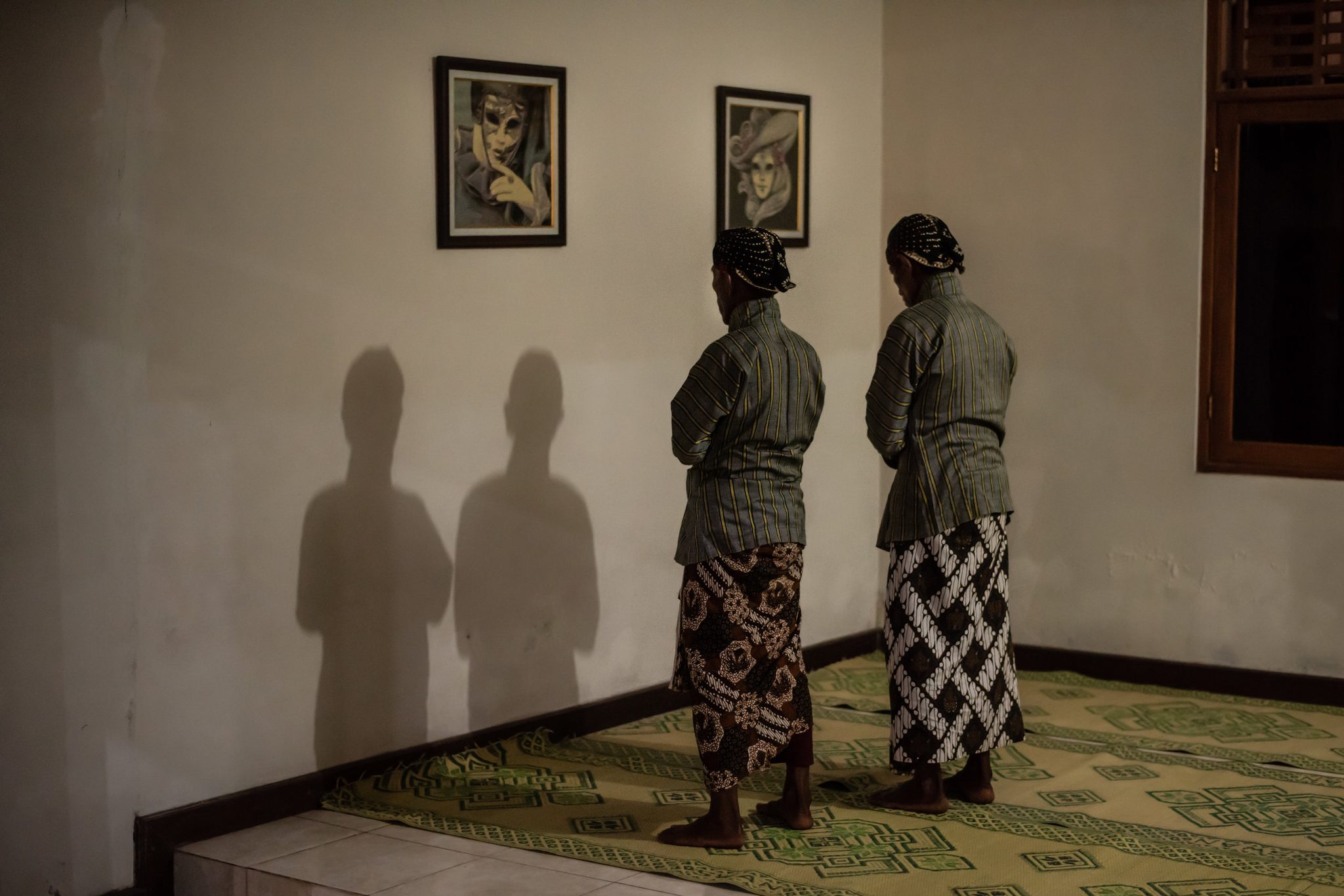 Performers pray before show