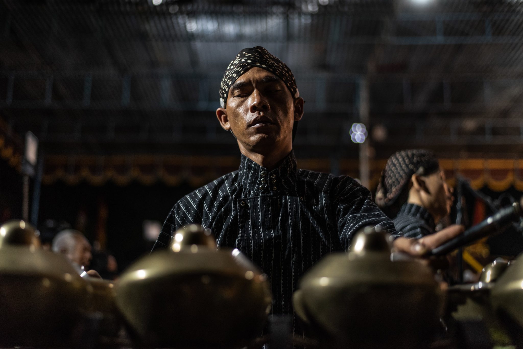 Gamelan player focuses