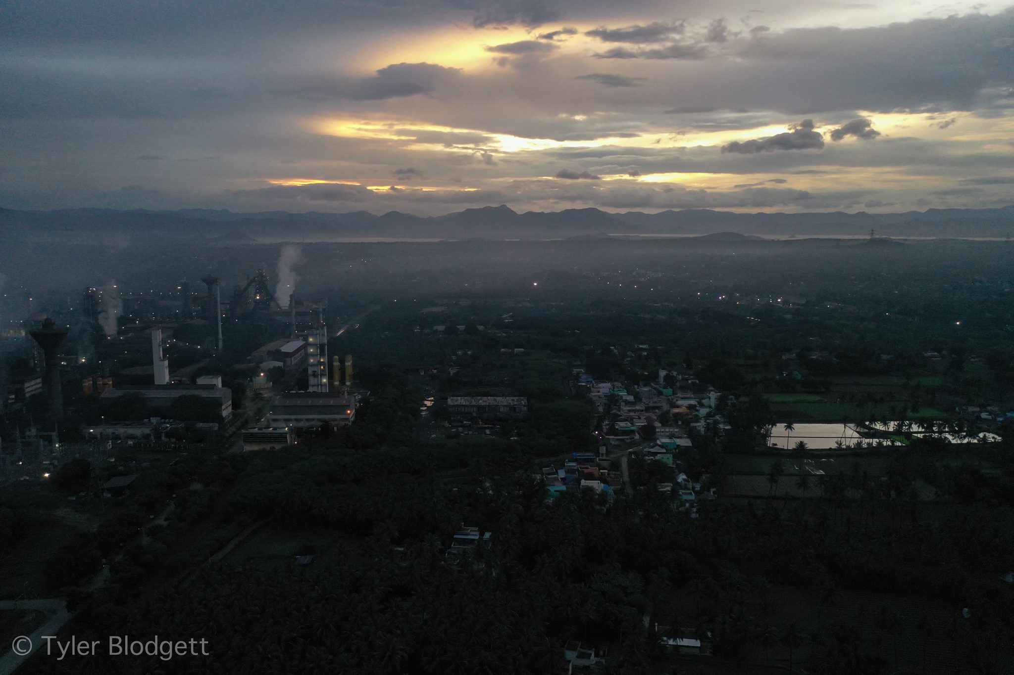 First light cuts through the clouds over the mill and the hills beyond.
