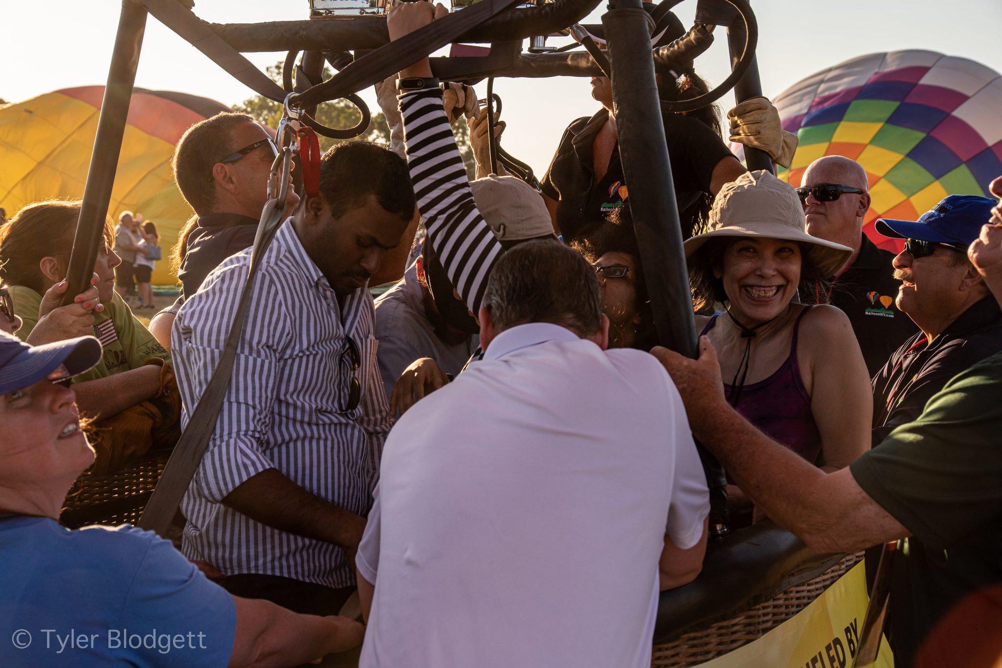 Passengers pack into the basket, and one woman can't stop grinning.