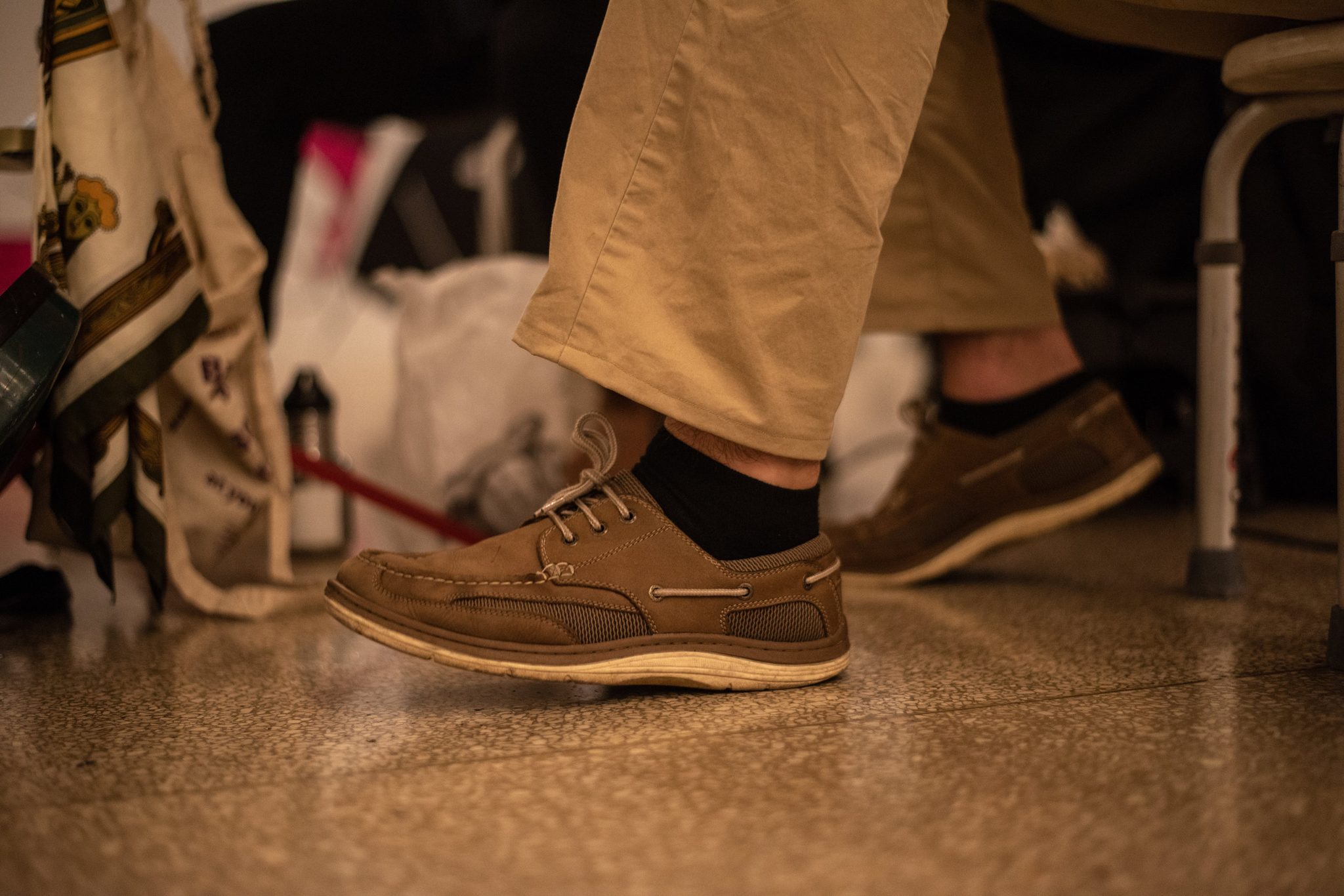 A boat shoe keeps time on the terminal floor.