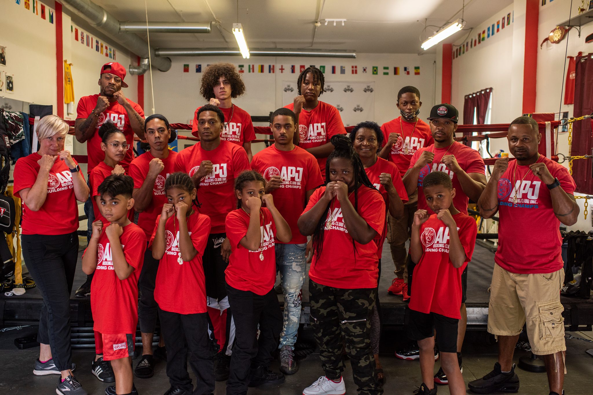 Kids in front, coaches at the edges, every fist raised.