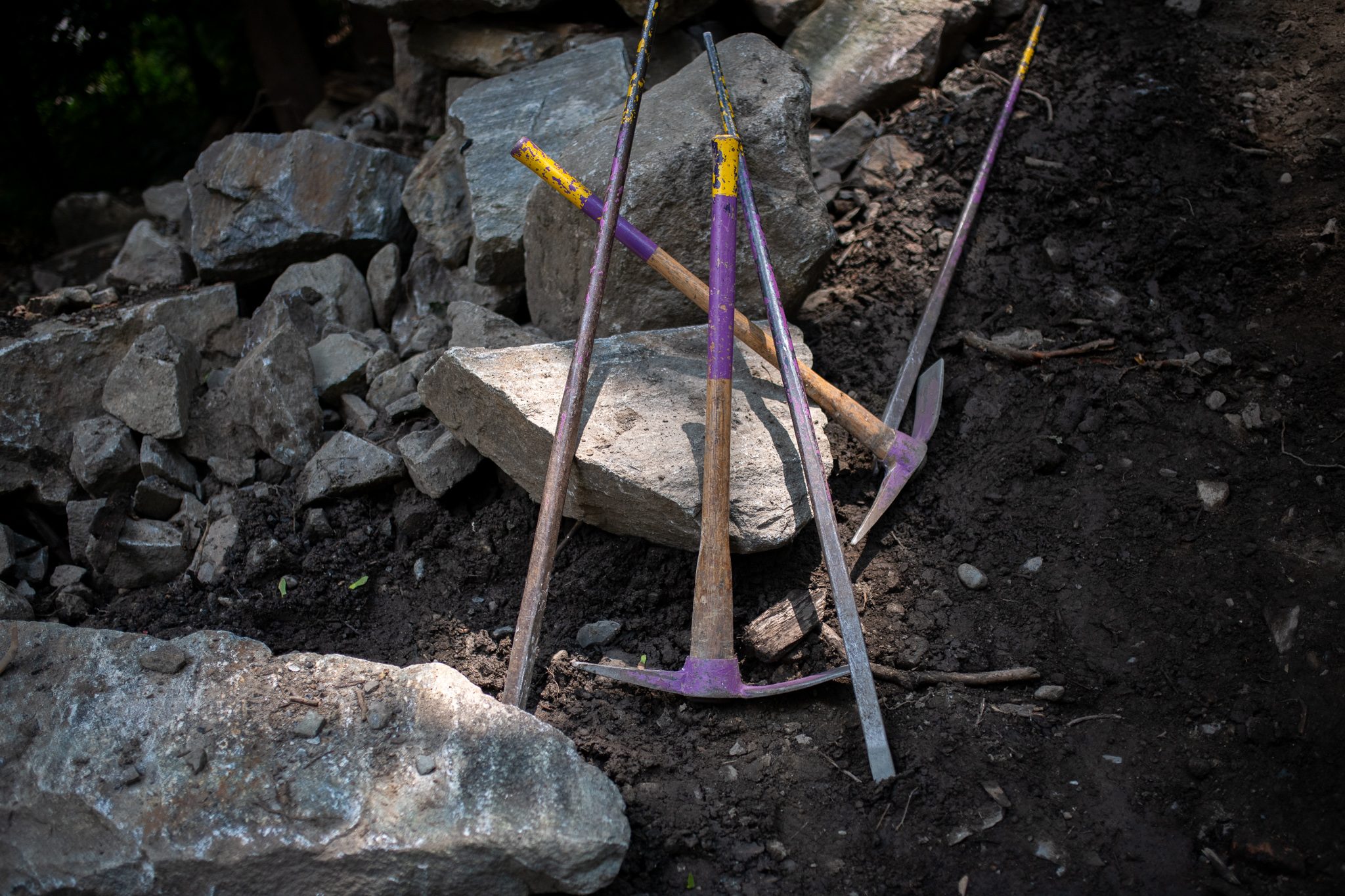 Picks and mattocks lean against the rubble at the end of the day.